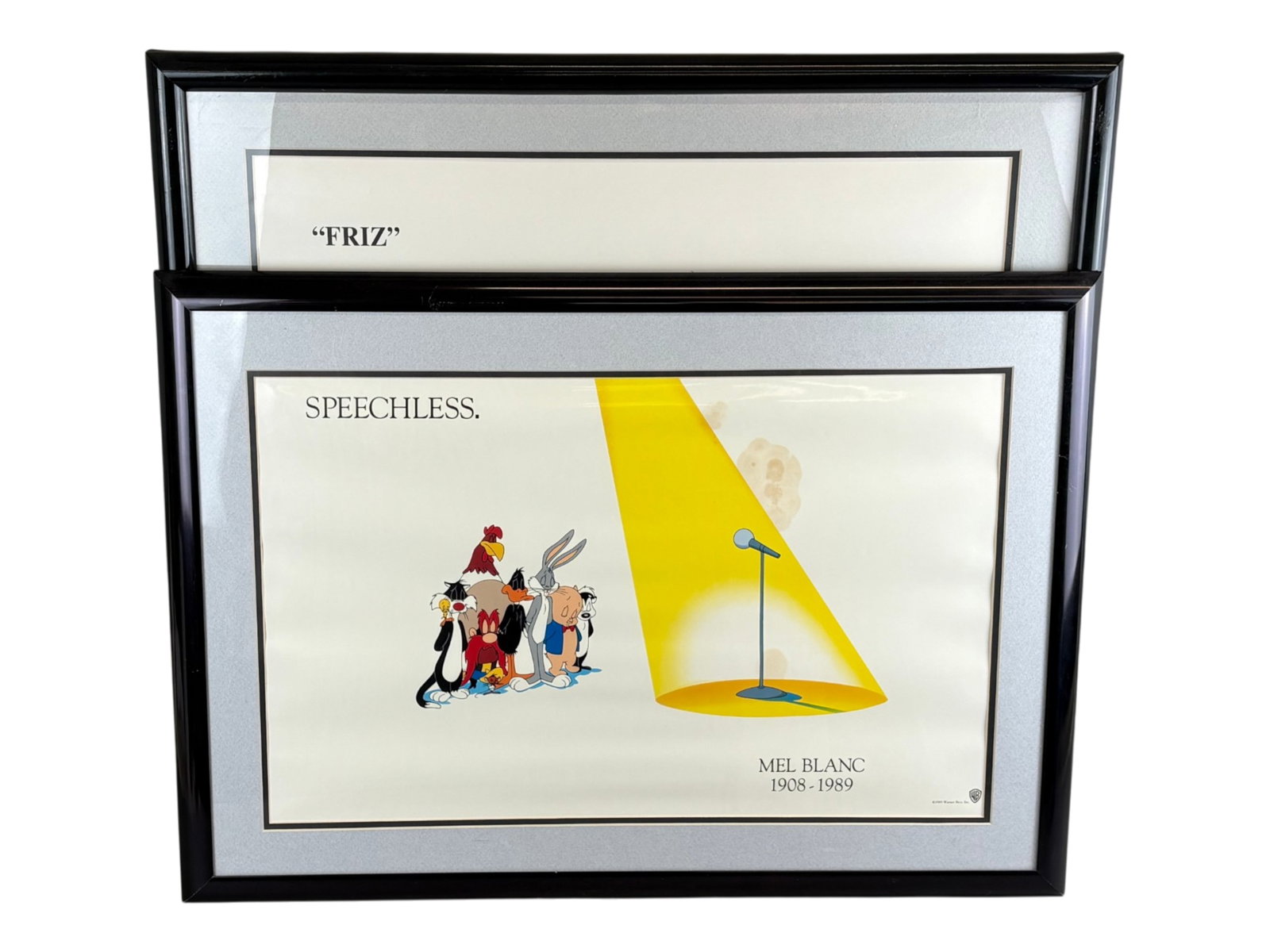 (2) Warner Brothers Tribute Fine Art Prints: (Warner Brothers, 1989 & 1995). Lot of 2 Tribute Fine Art pieces for Mel Blanc and Friz Freleng. Overall frame size of each approx. 31" x 22". The Mel Blanc print has some large stains. Shipping: Weis