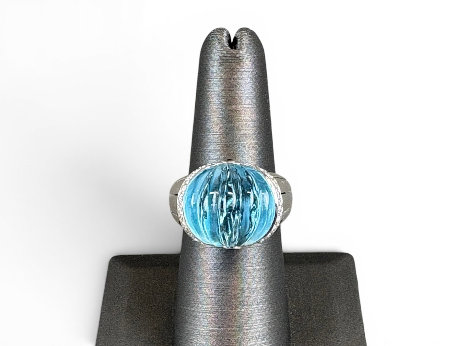 18K Gold Blue Topaz Diamond Ring: 18K white gold ring with Italian maker?s marks, set with a carved blue topaz at center and small blue topaz cabochons at the sides. Accented by 26 round brilliant-cut diamonds with an approximate