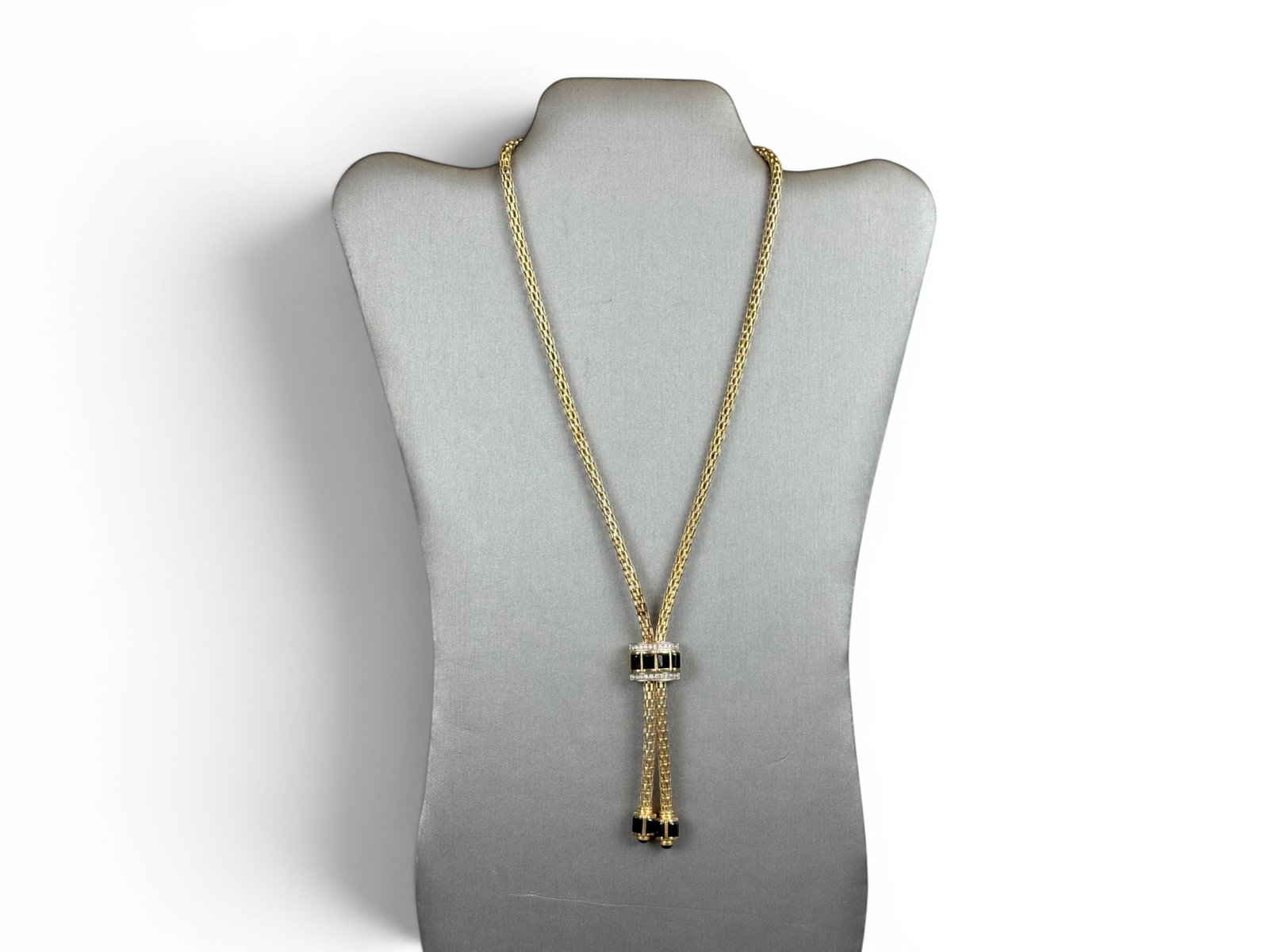 14K Gold Lariat Necklace: 14K gold lariat necklace accented with black onyx and diamond elements. Total weight approximately 30.3 grams. Shipping: Weiss Auctions offers full-service, in-house shipping for nearly all items in t