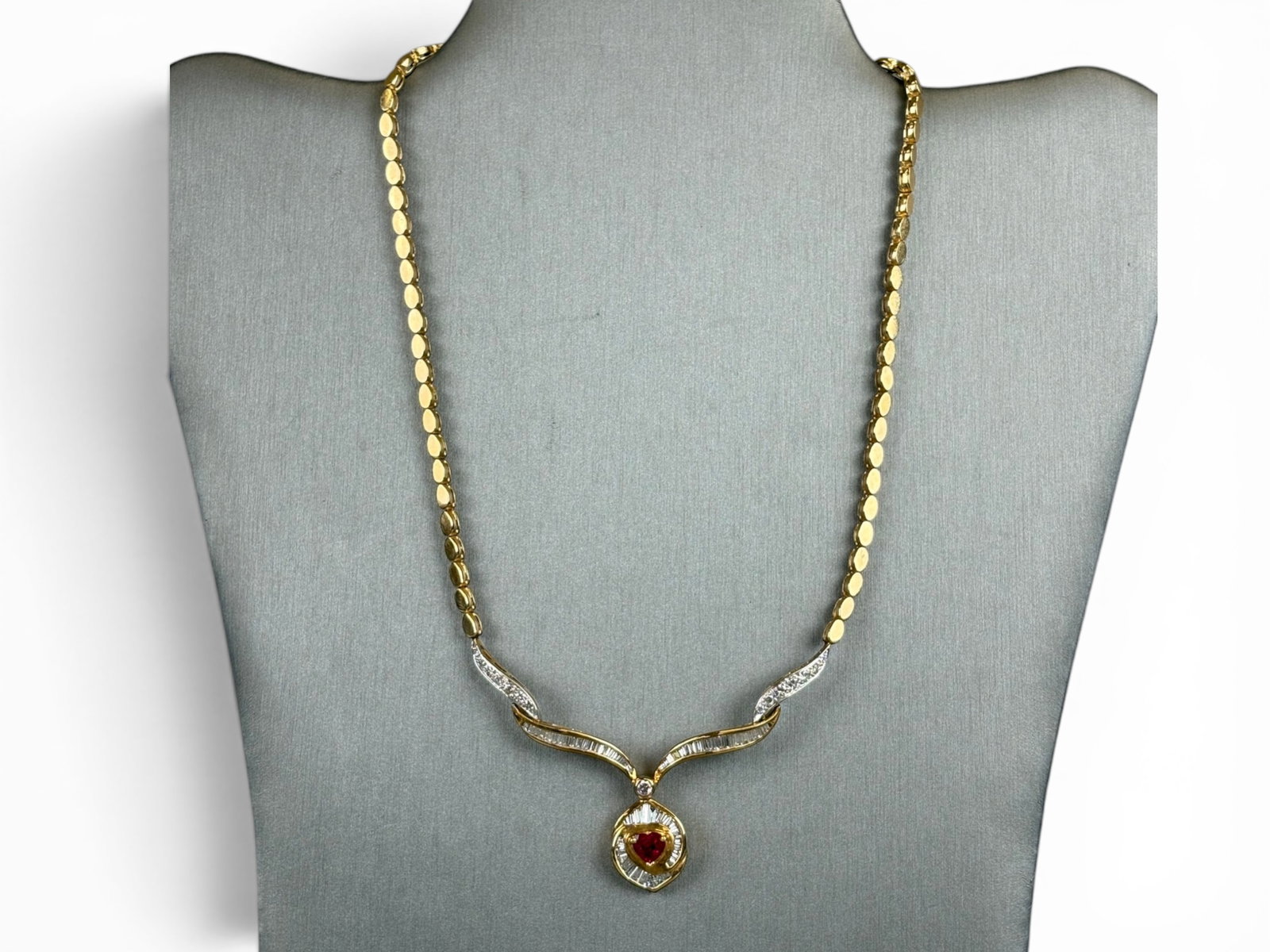 Custom 18K Ruby & Diamond Necklace: Custom 18K gold necklace set with a natural heart-shaped ruby weighing approximately 1.00 carat, likely Burmese origin, medium strong slightly purplish red in color, slightly included. Further set