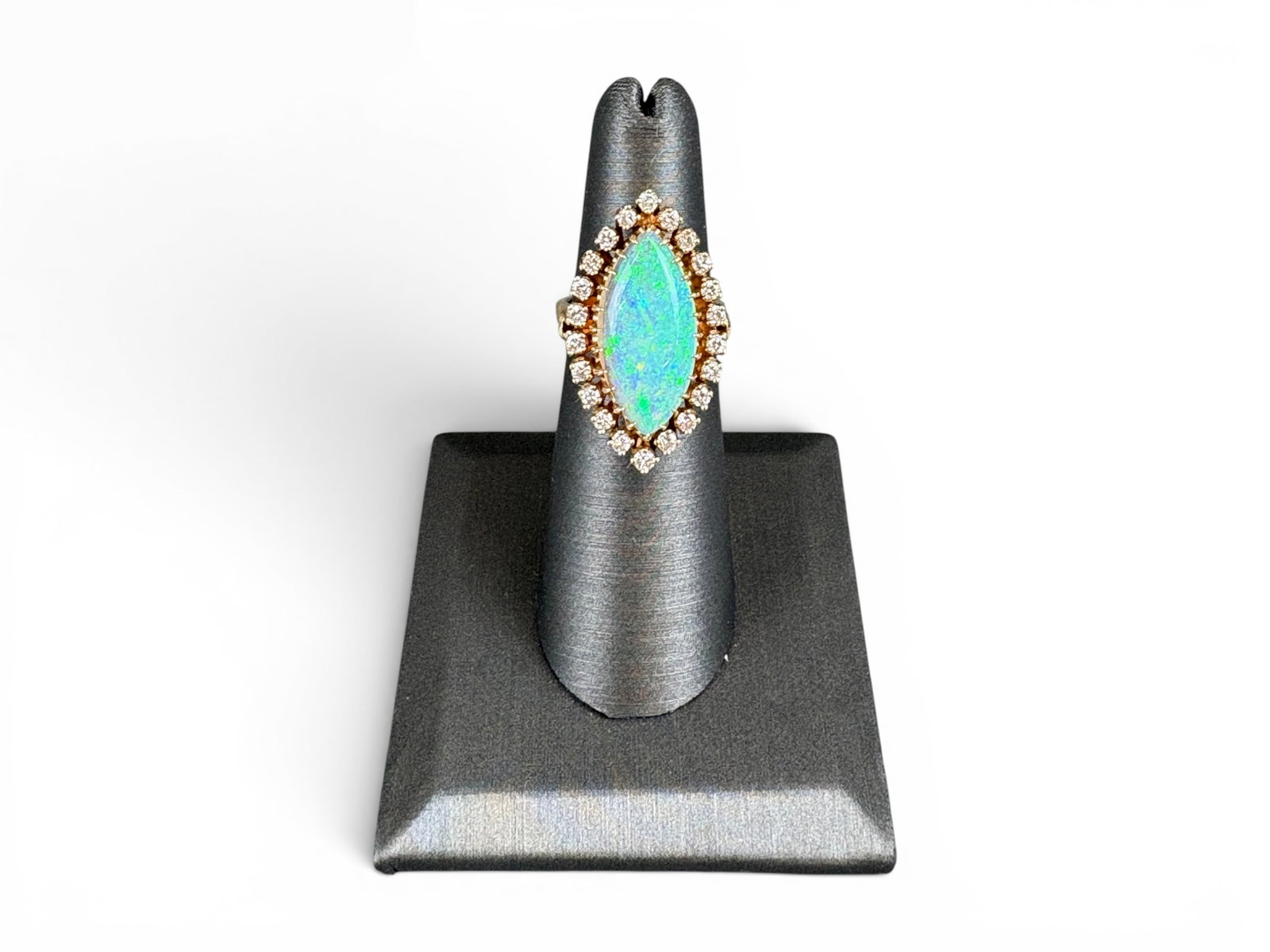 14K Gold Opal & Diamond Ring: 14K yellow gold ring set with a natural crystal opal cabochon in marquise form measuring approximately 20.52 x 10.12 x 3.00 millimeters, estimated weight 3.50 carats. Further set with round brilliant-