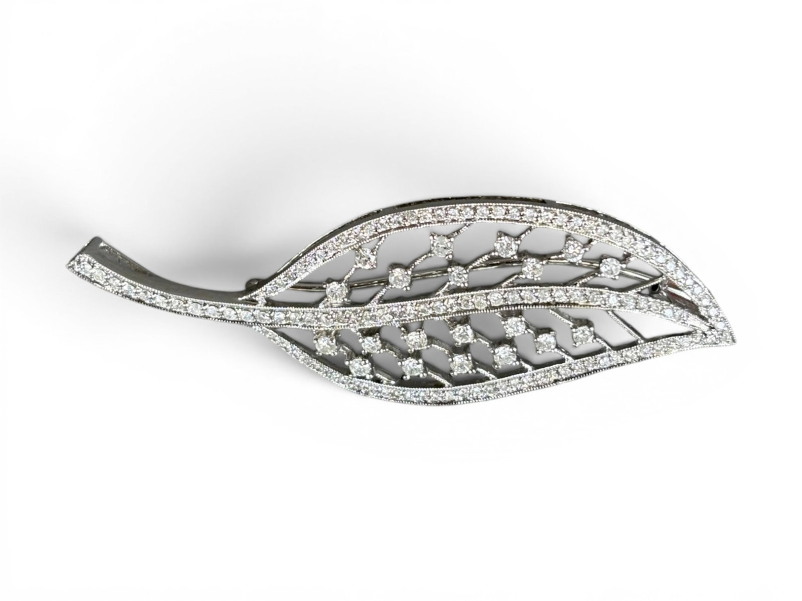 14K Gold Diamond Leaf Pin: 14K white gold diamond leaf pin measuring approximately 52 x 22 millimeters, set with diamonds having an approximate total weight of 1.00 carat, I-J color, included 2 to included 3 clarity. Total