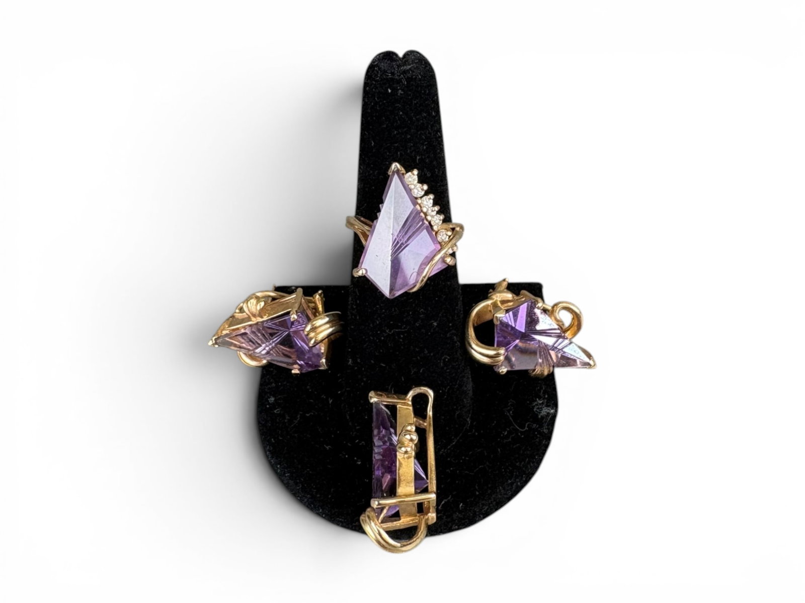 14K Gold Amethyst Jewelry Set: 14K yellow gold jewelry set with fantasy-cut amethyst, including ring, pair of earrings with omega clip backs, and pendant. Total weight approximately 24 grams. Shipping: Weiss Auctions offers full-se