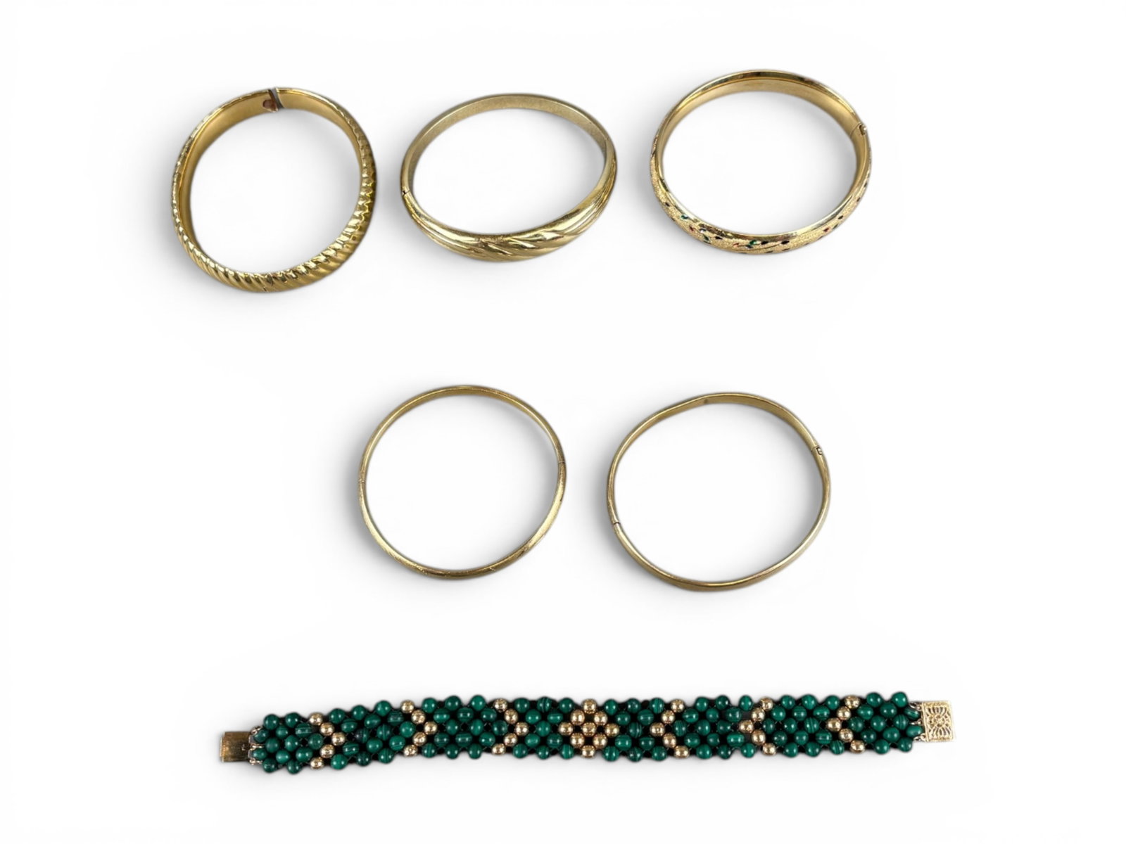(7) 14K Yellow Gold Bracelets: Estate gold jewelry lot including seven 14 karat yellow gold bracelets, one accented with malachite beads. Total combined weight approximately 62.0 grams. Offered on behalf of the New York County Publ