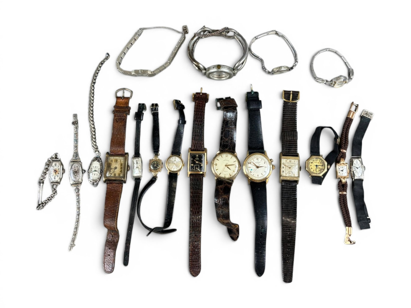 (18) Gold & Vintage Wristwatches: Group of 18 wristwatches including an 18 karat Omega manual wind tank watch weighing 6 grams, a quartz bracelet watch, a 14 karat white gold Bulova Art Deco tank watch, 14 karat white gold Lucien Pica
