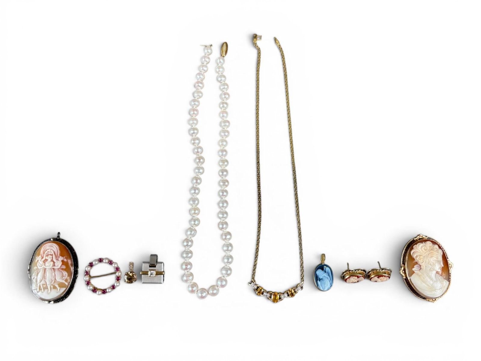 Estate Gold Jewelry Collection: Estate jewelry collection including a 10K yellow gold citrine and small diamond necklace, 14K cameo pieces, and a variety of 14K white and yellow gold jewelry. Shipping: Weiss Auctions offers full-ser