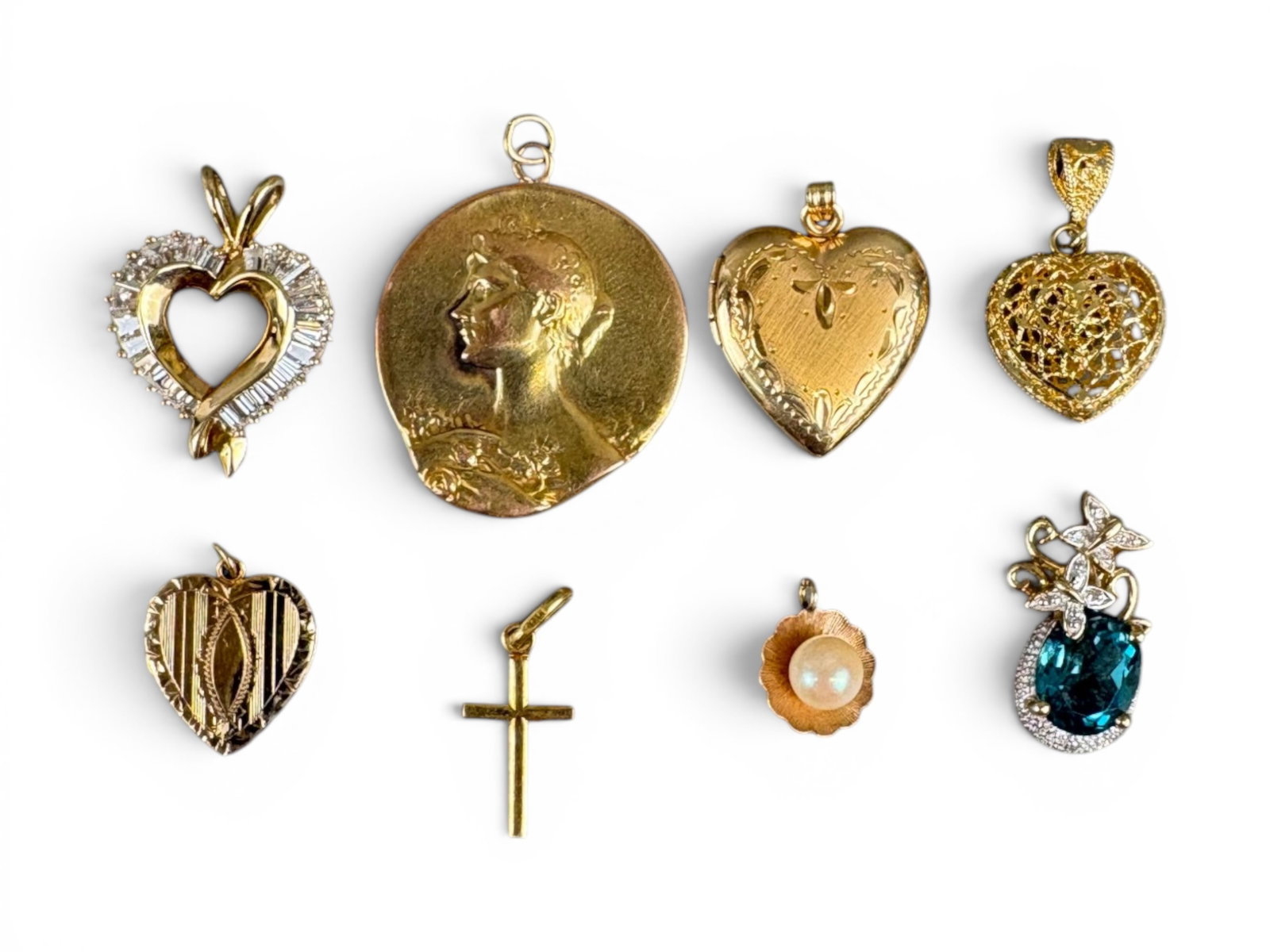 Gold Charms & Pendants Group: Group of gold charms and pendants including one 18K, seven 14K, and one 10K example, including a topaz-set piece. Total weight approximately 22.8 grams. This lot is being offered on behalf of the