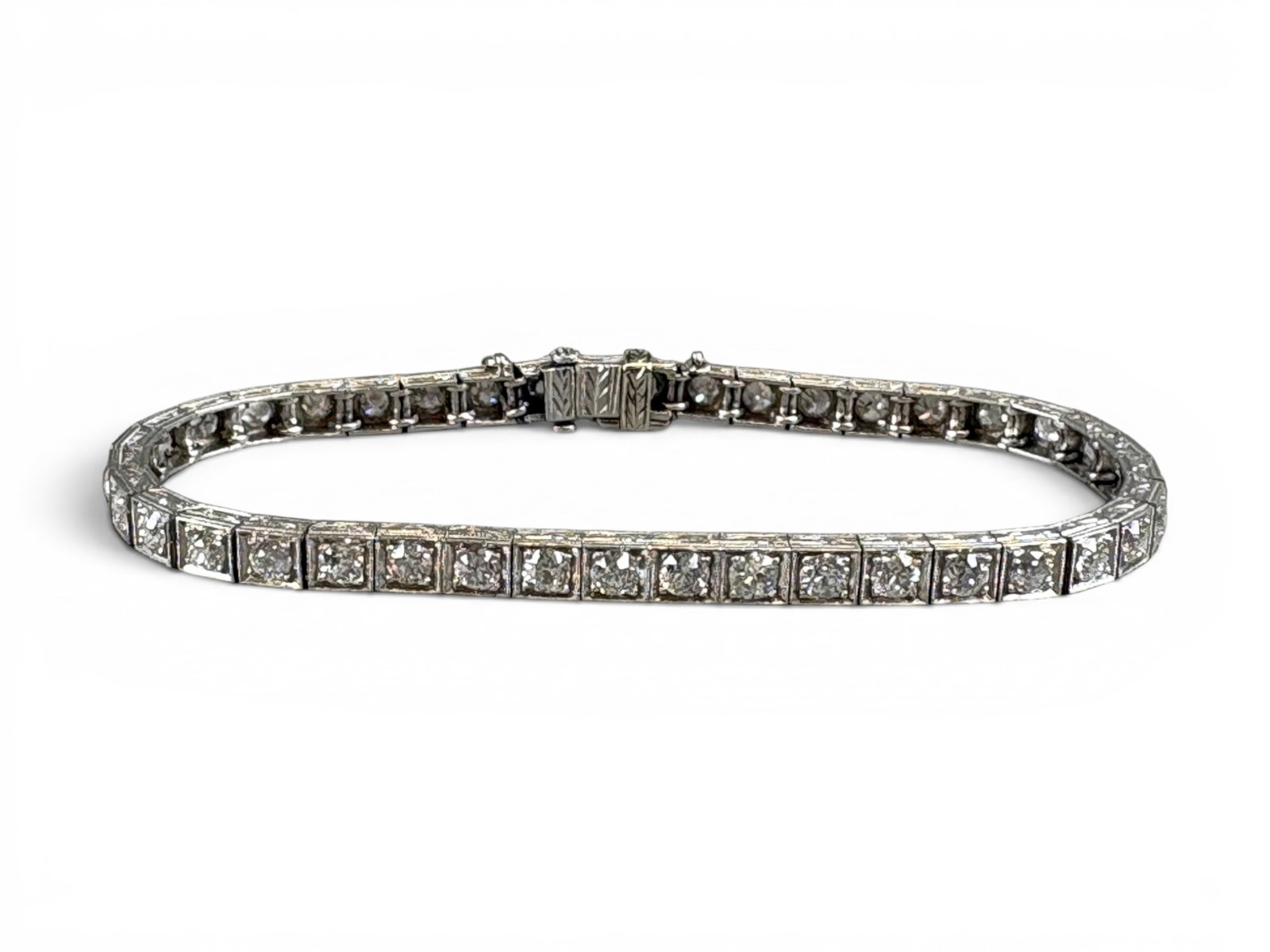 Platinum Art Deco Diamond Bracelet: Vintage platinum Art Deco diamond line bracelet, circa 1920, set with 40 old European-cut diamonds having an approximate total weight of 4.75 carats, H-I color, slightly included 1 to included 1
