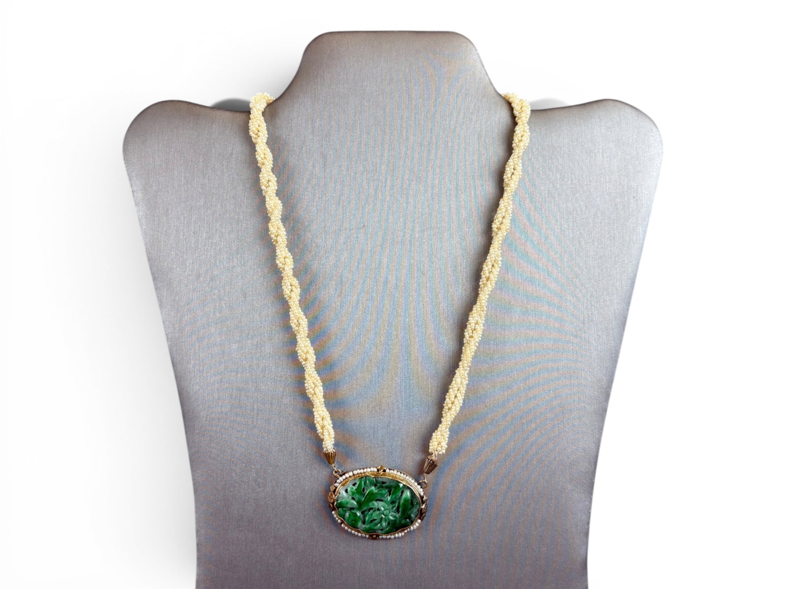 14K Gold Jadeite Pendant Necklace: 14K gold framed carved jadeite pendant on necklace measuring approximately 18 inches in length. Total weight approximately 21.9 grams. Shipping: Weiss Auctions offers full-service, in-house shipping