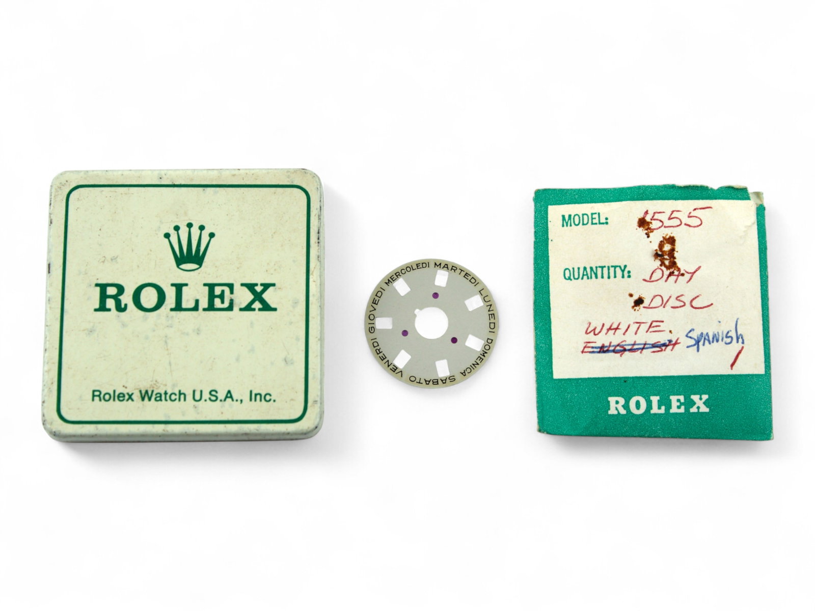 Rolex Day Disc 1555 Spanish in Tin: Rolex model 1555 Day Disc, Spanish, in original Rolex parts tin. Shipping: Weiss Auctions offers full-service, in-house shipping for nearly all items in this auction. For a shipping quote, please
