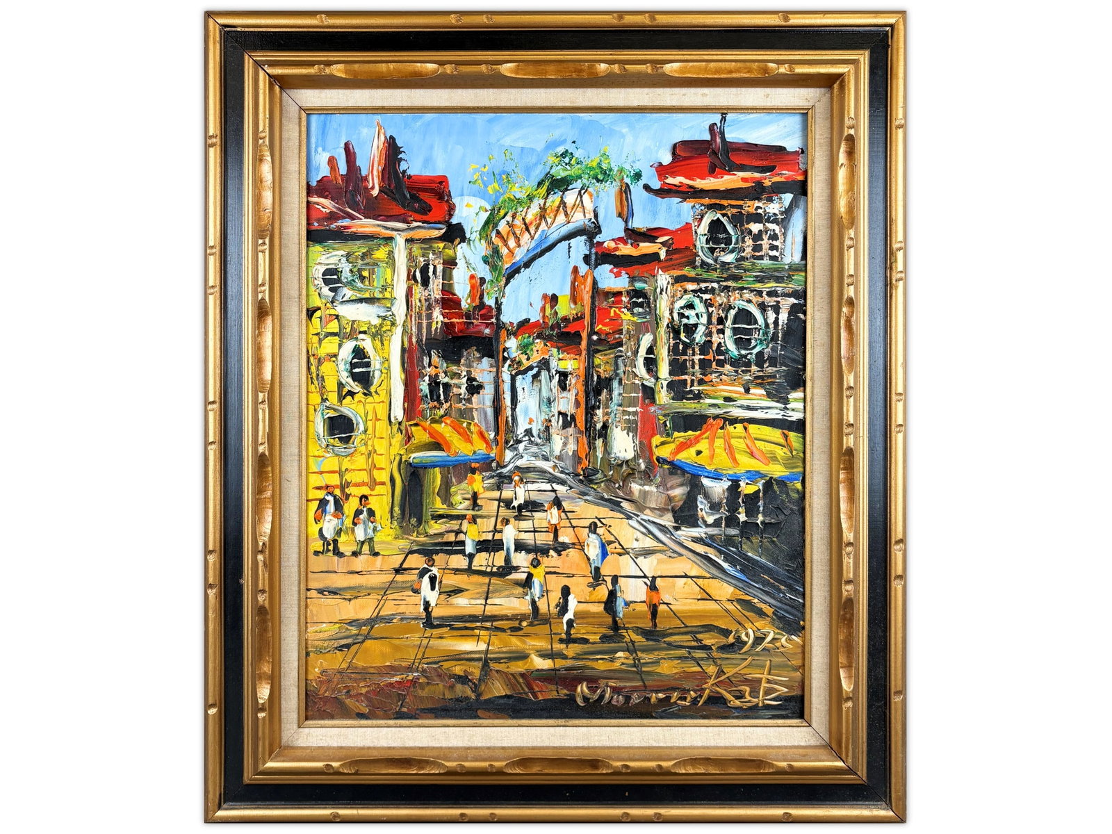 Morris Katz Mixed Media Painting on Board: Morris Katz (American, 1932-2010). Mixed media painting on illustration board depicting a bustling village street scene with figures walking among colorful buildings beneath a bright blue sky.