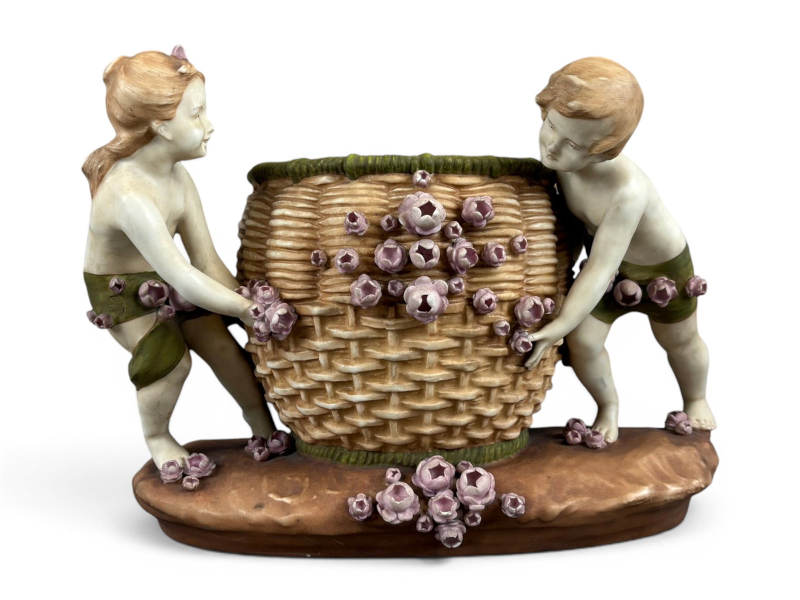 Amphora Figural Centerpiece Planter w/Children: Large Amphora figural pottery centerpiece planter depicting two children pushing and supporting a woven flower basket overflowing with applied pink blossoms. Executed with finely modeled figures,
