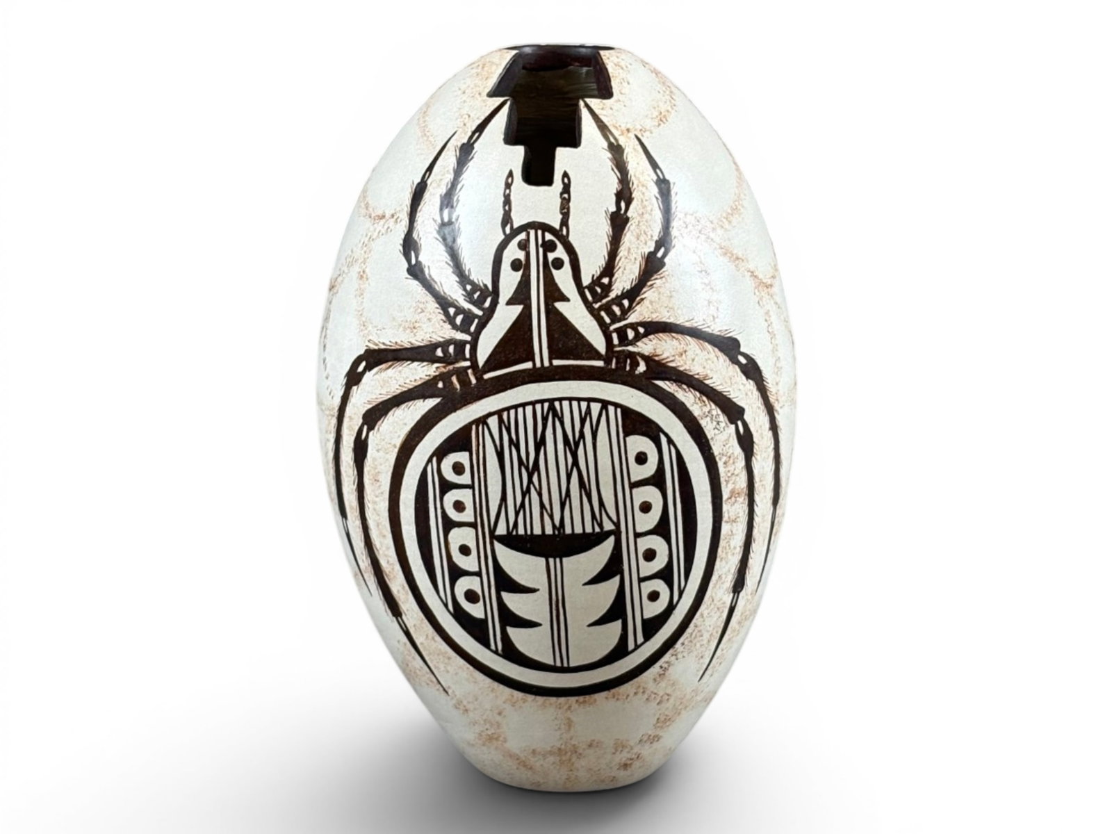 Burel Naha, Hopi-Tewa Pottery Seed Jar: Native American Hopi-Tewa pottery seed jar by Burel Naha, decorated with a stylized spider motif and geometric elements in brown, black, and red tones on a cream ground. Features a carved opening at t