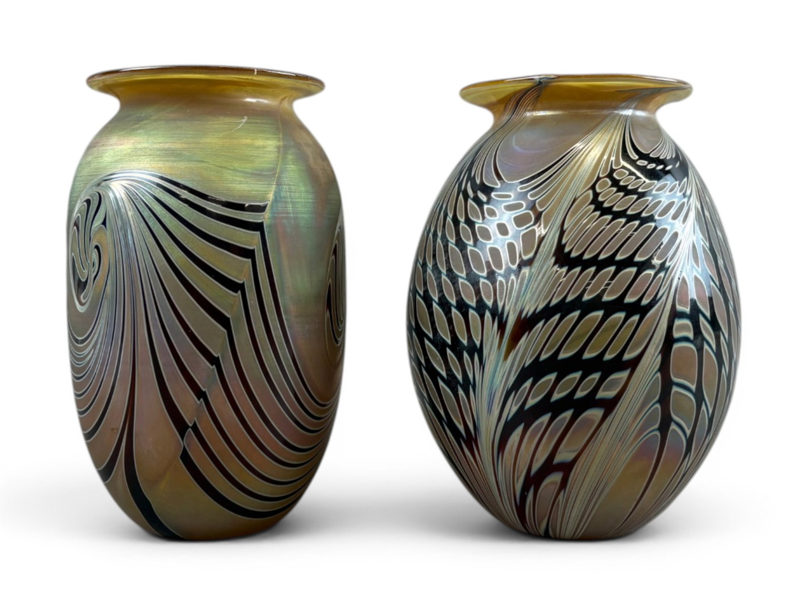 Pair of Craig Zweifel Art Glass Vases: Pair of Craig Zweifel studio art glass vases, each featuring intricate pulled line and feather-style decoration with iridescent surfaces and amber-toned rims. Both examples retain etched signatures