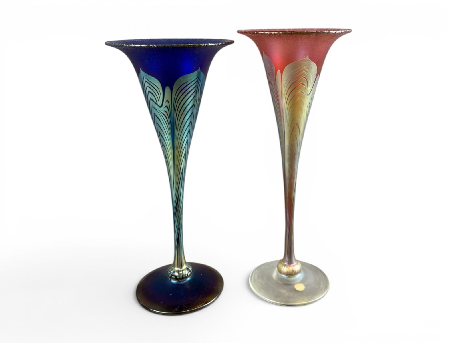 (2) Correia Studio Art Glass Trumpet Vases: Pair of Correia studio art glass trumpet vases featuring tall flared forms with iridescent finishes and stylized feather decoration extending through the stems and bowls. One example displays deep