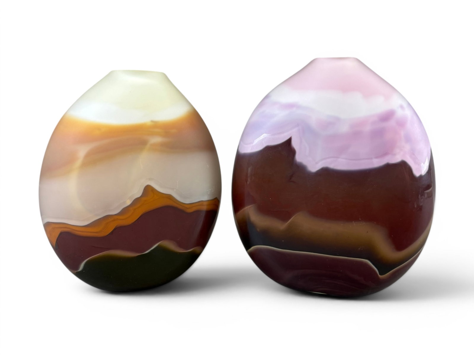 (2) Jim & Connie Grant Studio Art Glass Vases: Pair of Jim and Connie Grant studio art glass vases, circa 1980's. Each featuring softly blended layered bands of pastel and earth-tone coloration in a formations landscape-style design. One example