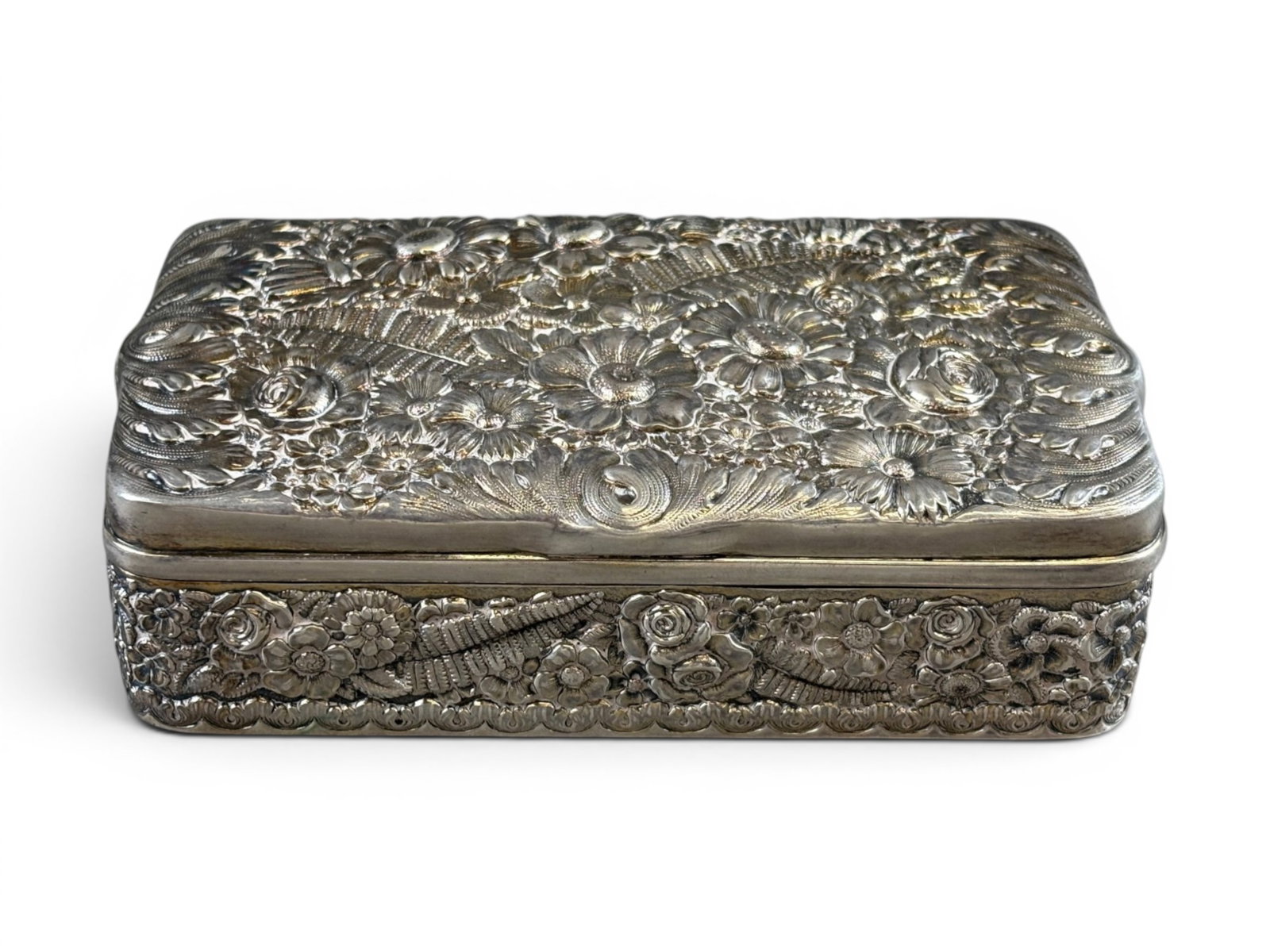 Tiffany & Co Sterling Silver Box: Tiffany & Co. sterling silver box with floral decoration. Marked ?Tiffany & Co. 8661 Makers S7 Sterling Silver 925/1000 T.? Approx. 5 3/8" x 1/2" x 3" and weighing approx. 259 grams. Shipping: Weiss A