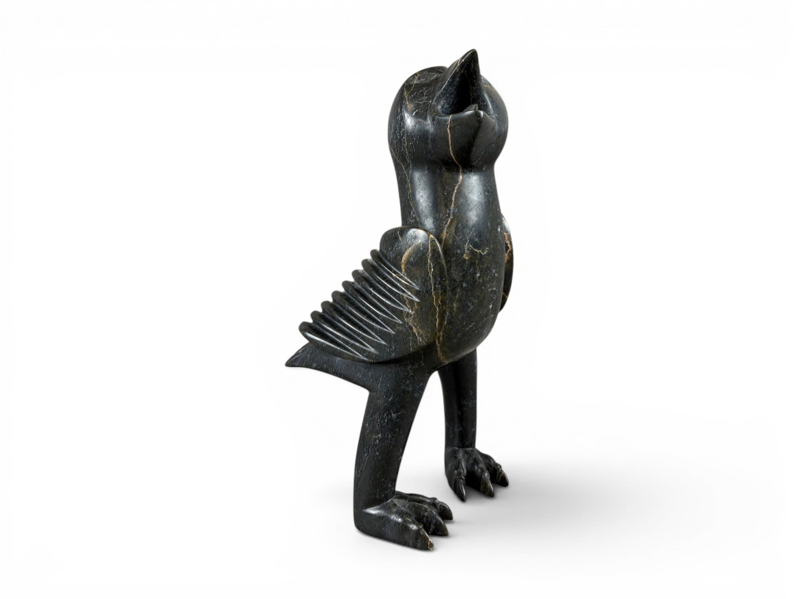 Large Inuit Stone Eagle Sculpture: Large Inuit carved stone eagle sculpture. Approx. 14 1/2'' tall. Shipping: Weiss Auctions offers full-service, in-house shipping for nearly all items in this auction. For a shipping quote, please