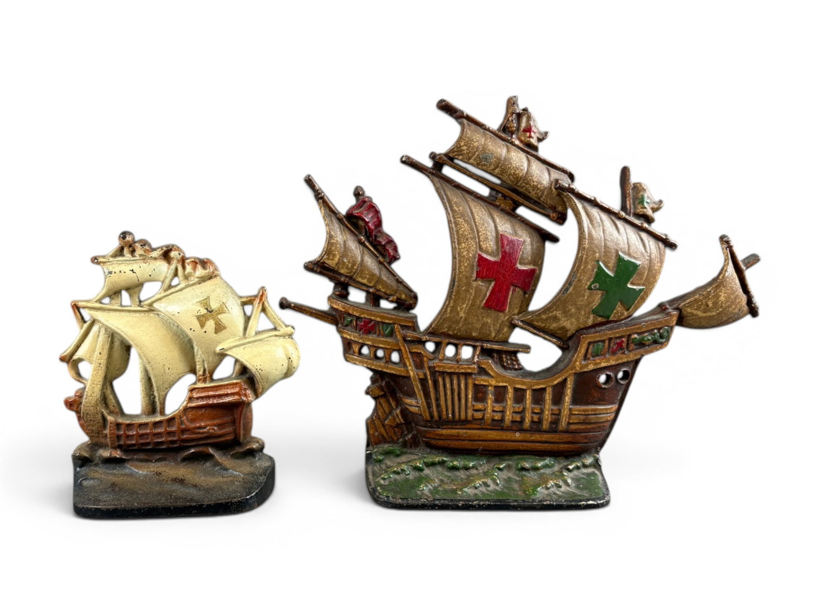 (2) Cast Iron Figural Sailing Ship Doorstops: Spanish Galleon Type, approx. 13.5" x 11". Original paint. Some worn paint and surface and edge wear. Smaller ship approx. 7-1/2" tall, verso marked Copyright 1930, Creation Co. Also shows worn paint 