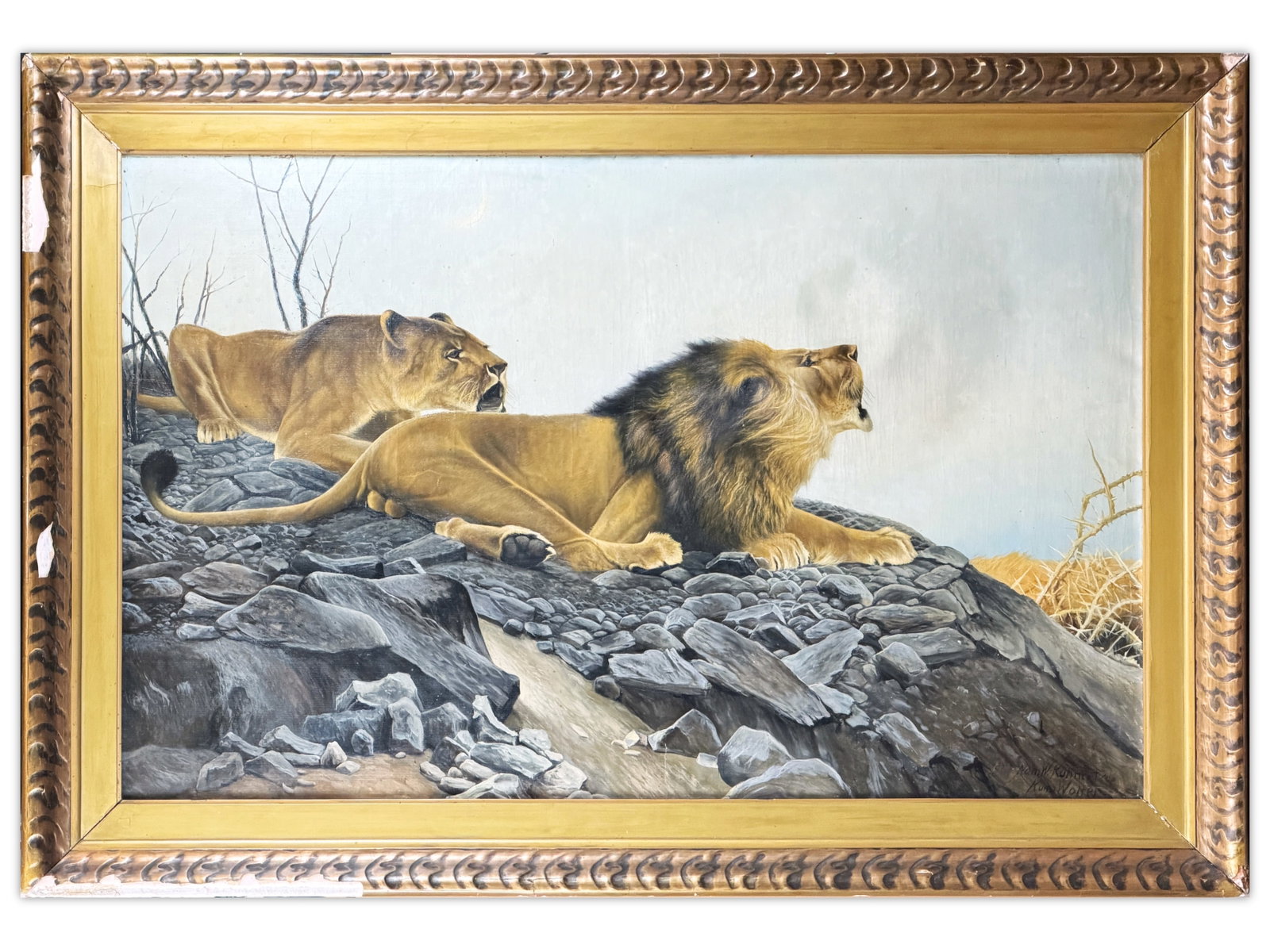 After Wilhelm Kuhnert, Lion Oil Painting: Large oil on canvas painting, After Wilhelm Kuhnert (German, 1865-1926), depicting a lion and lioness resting among rocky terrain, both figures alert and gazing outward. The composition reflects