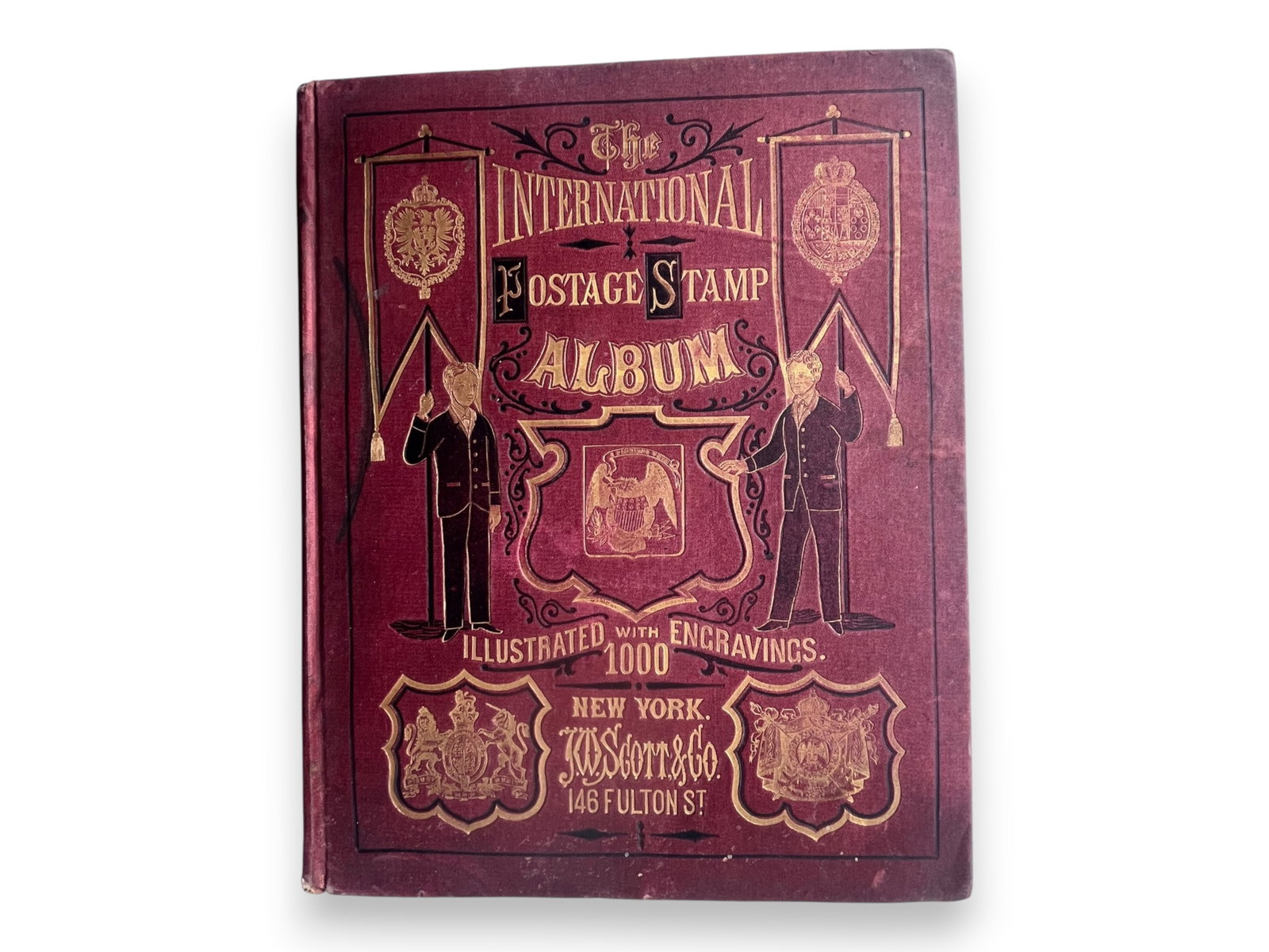 1875 Scott Postage Stamp Album: Historic 1875 Scott Postage Stamp Album, the first album published by J. Walter Scott. Original gilt-decorated cloth binding. Contains a scattering of 19th century stamps, including several useful