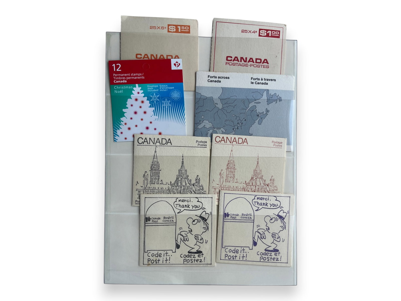Lindner Albums & Ephemera (9 Vols.): Nine Lindner hingeless albums including souvenir cards, currency-related ephemera with fractional currency, and five albums of Canadian stamp booklets with substantial face value. Shipping: Weiss