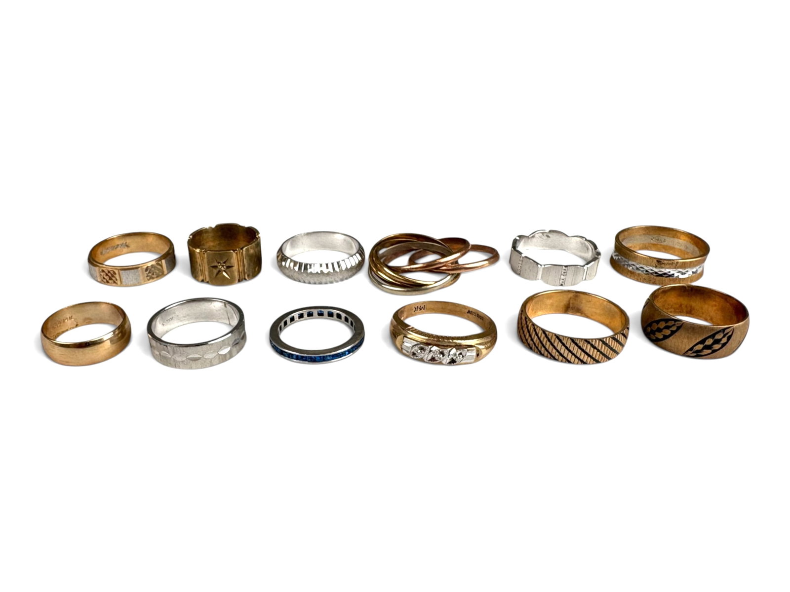(12) 14K Gold Rings: (12) 14K gold rings in various designs and sizes, including one channel-set ring with synthetic blue stones. Total weight approximately 66.7 grams.This lot is being offered on behalf of the Kings Coun