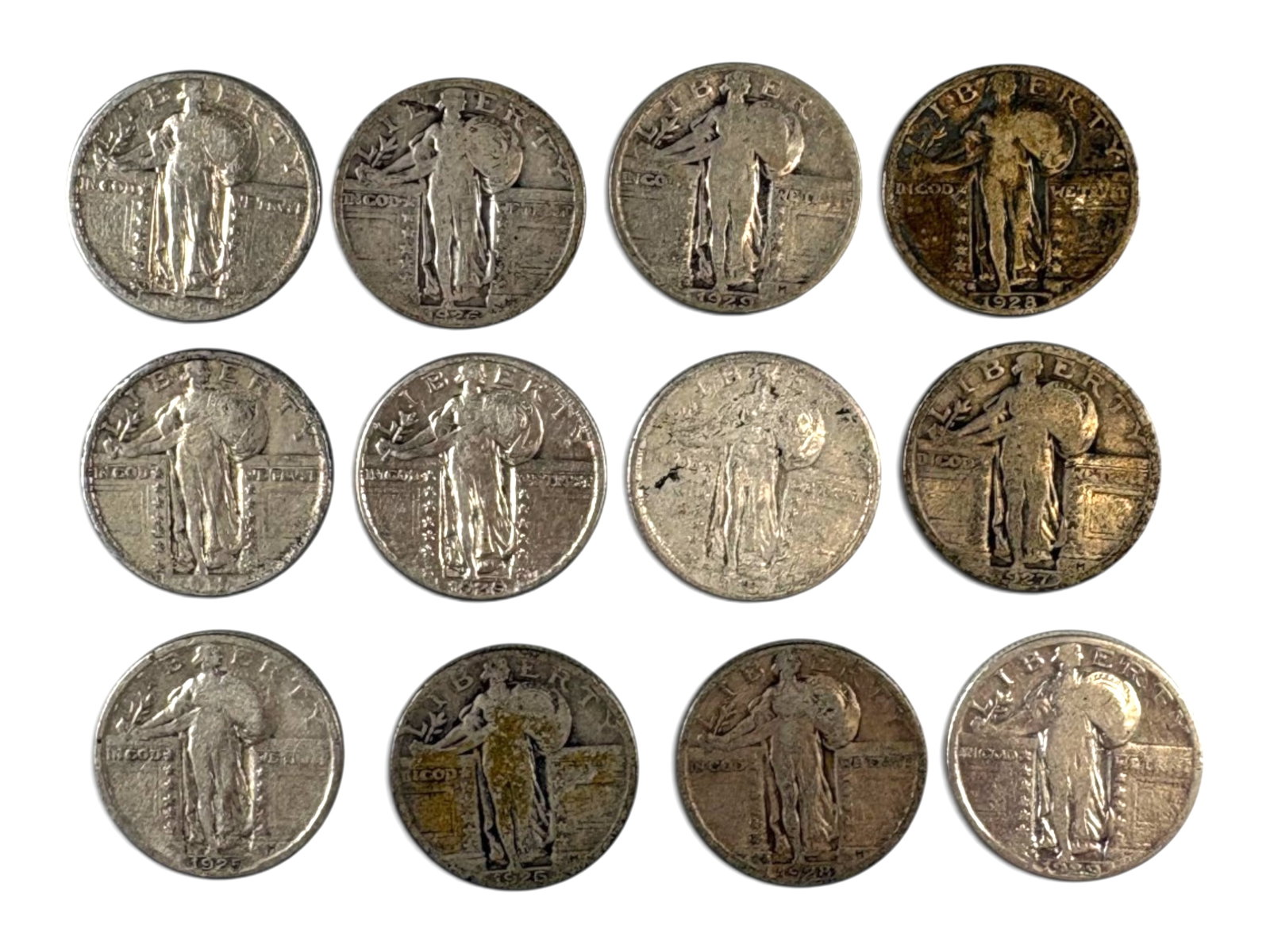 (12) Standing Liberty Quarters: Group of (12) Standing Liberty quarters with legible dates. Mixed grades. Ungraded. See images for condition. Shipping: Weiss Auctions offers full-service, in-house shipping for nearly all items in