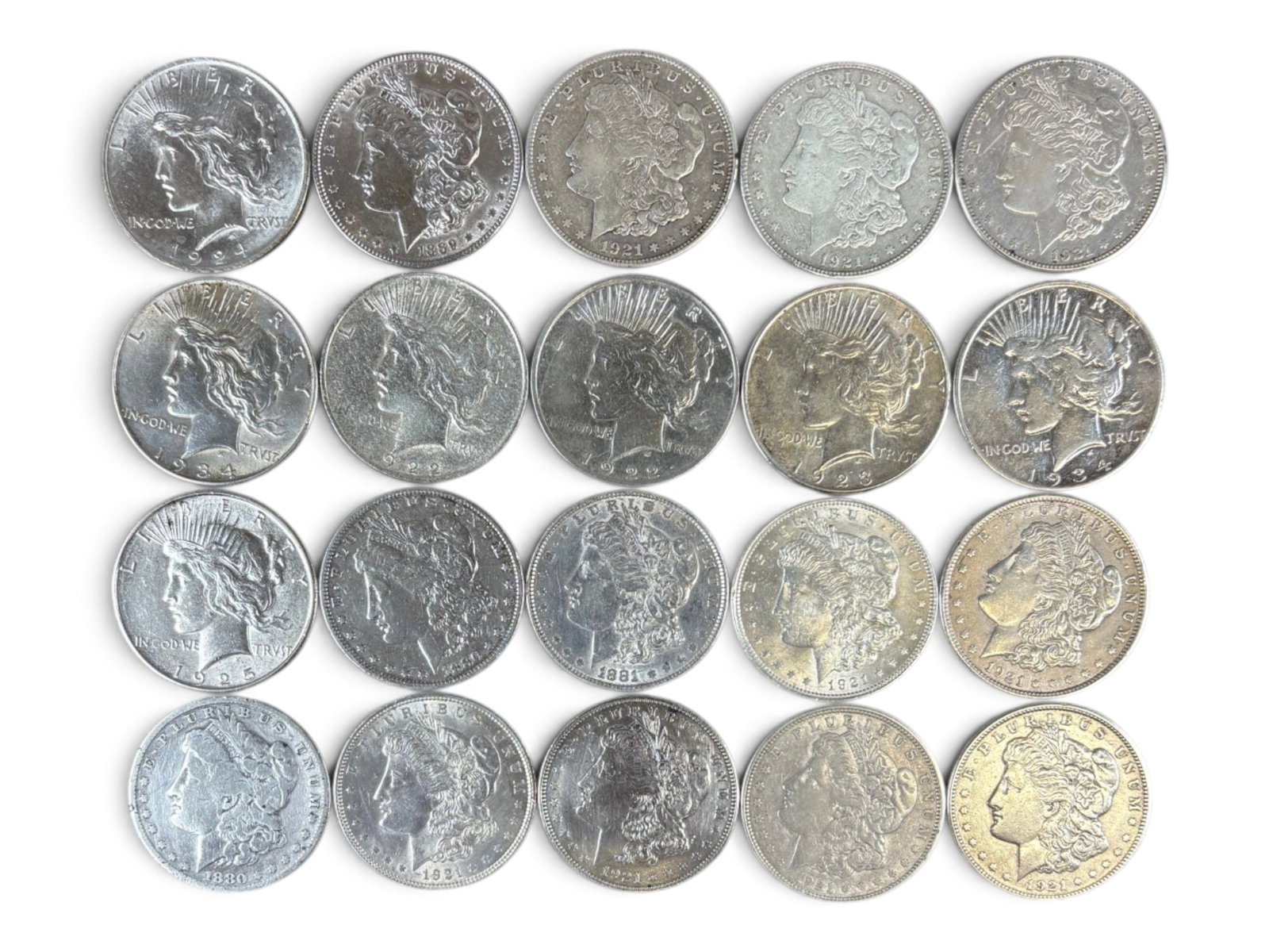 (20) Morgan & Peace Dollars: Group of 20 Morgan and Peace silver dollars with mixed dates and conditions. Shipping: Weiss Auctions offers full-service, in-house shipping for nearly all items in this auction. For a shipping