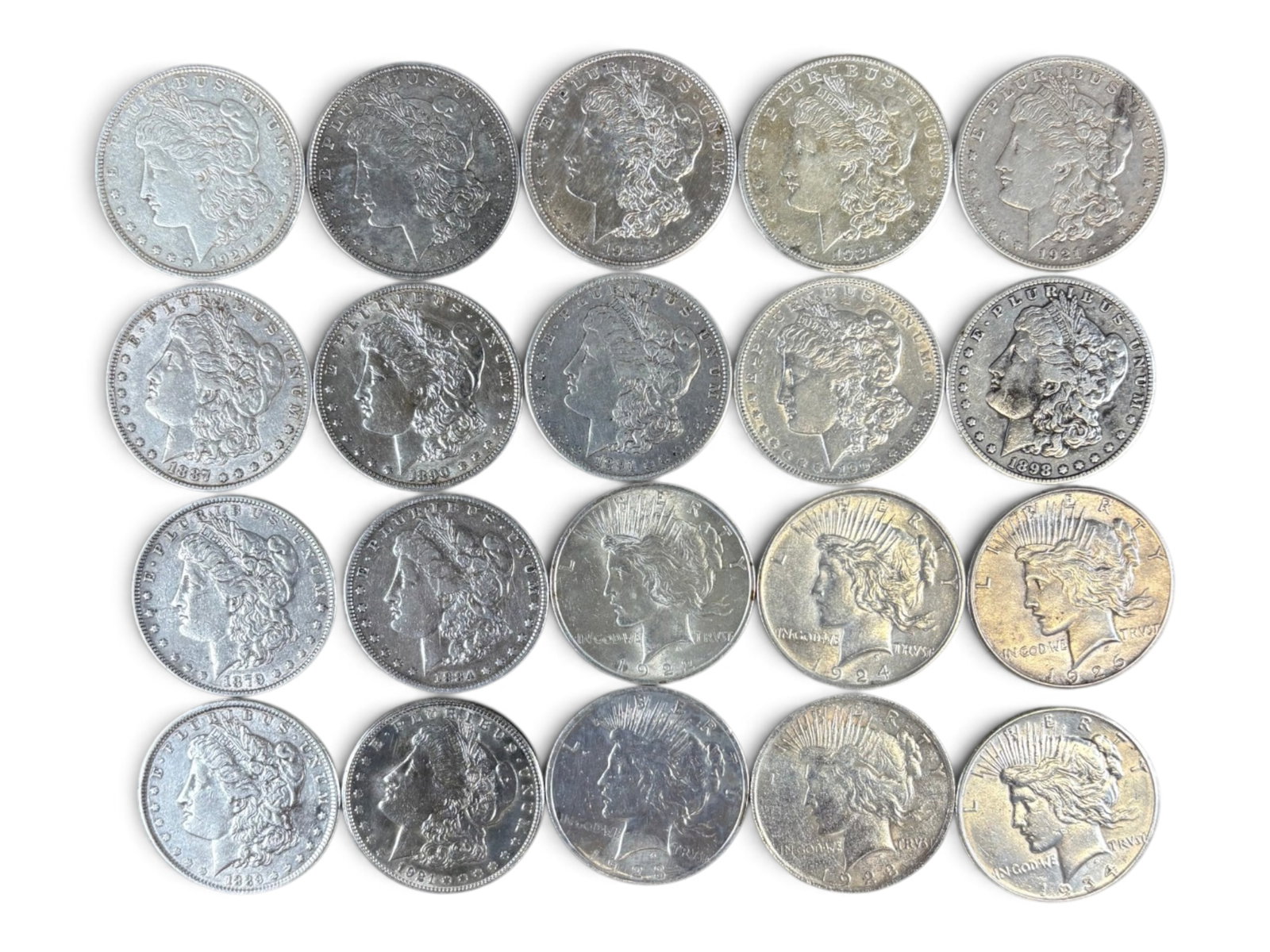 (20) Morgan & Peace Dollars: 20 Morgan and Peace silver dollars with mixed dates and conditions. Shipping: Weiss Auctions offers full-service, in-house shipping for nearly all items in this auction. For a shipping quote, please