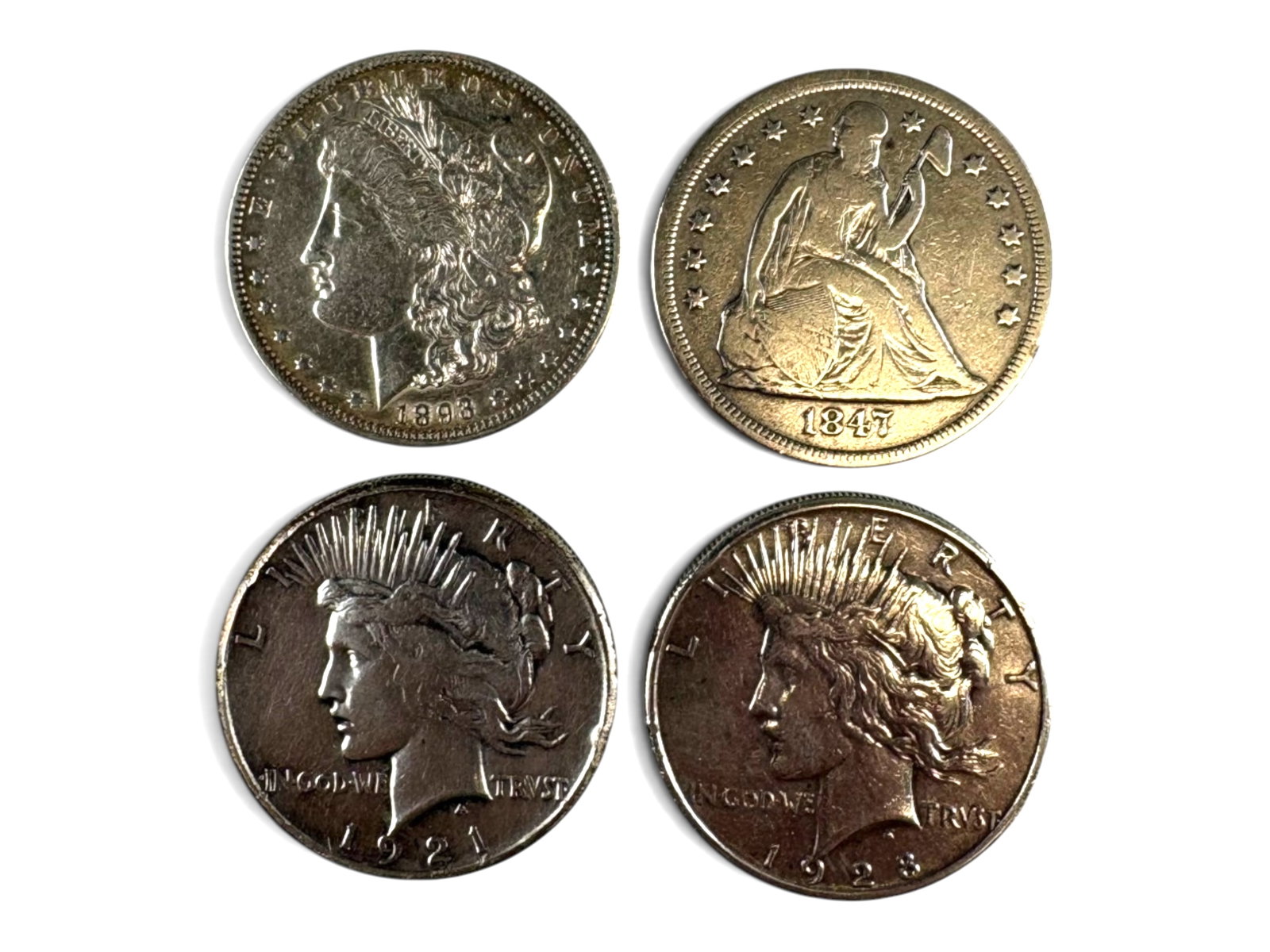 1847, 1893-O, 1921 & 1928 Silver Dollars: 1847 Seated Liberty Dollar, 1893-O Morgan Dollar, 1921 Peace Dollar, and 1928 Peace Dollar. Ungraded. See images for condition. Shipping: Weiss Auctions offers full-service, in-house shipping for near