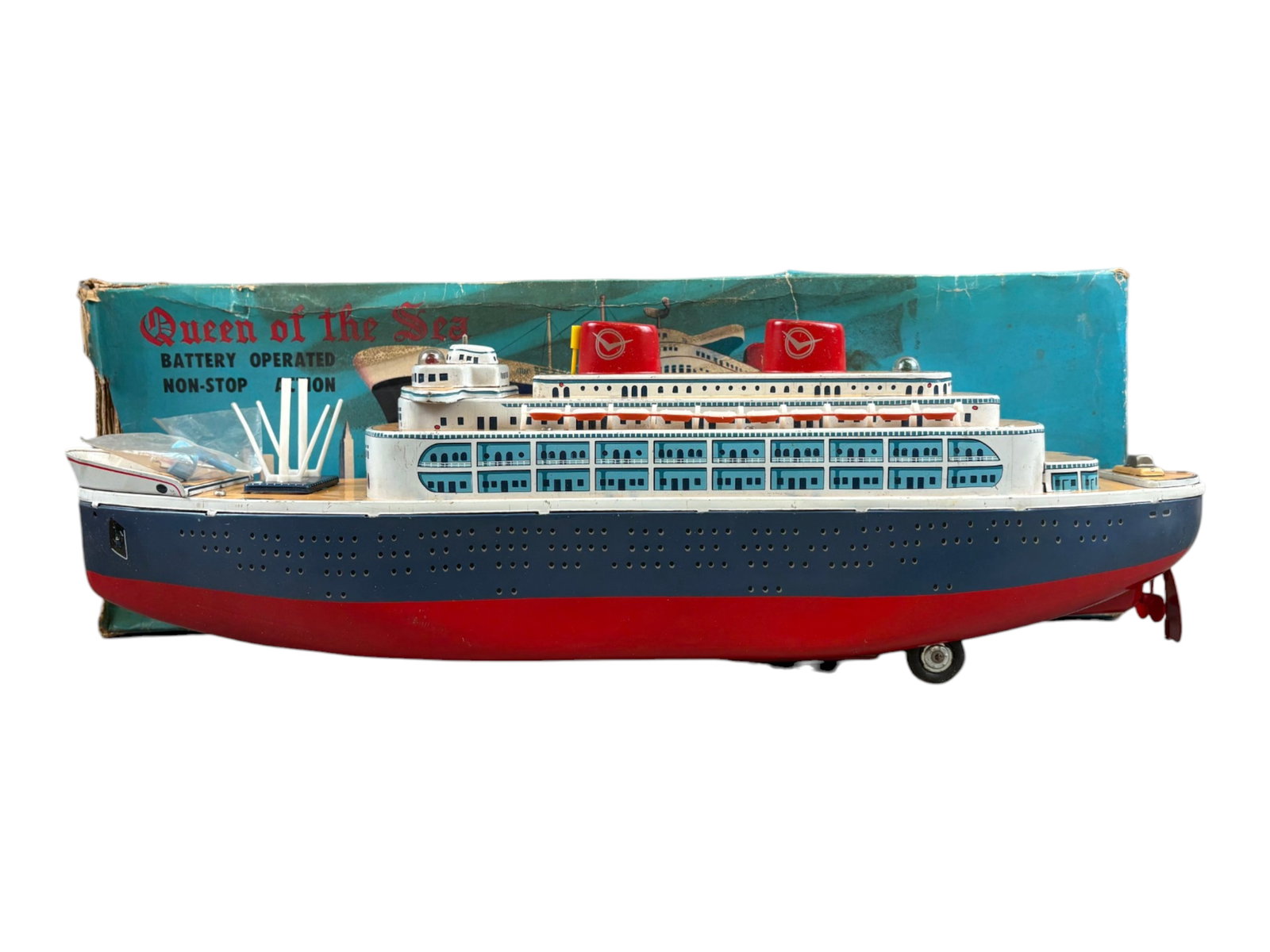 Masudaya Queen of the Sea: Masudaya battery-operated "Queen of the Sea" ocean liner measuring approximately 22 inches long. Tested prior to cataloging and found to be in working order, with lights functioning and bump-and-go