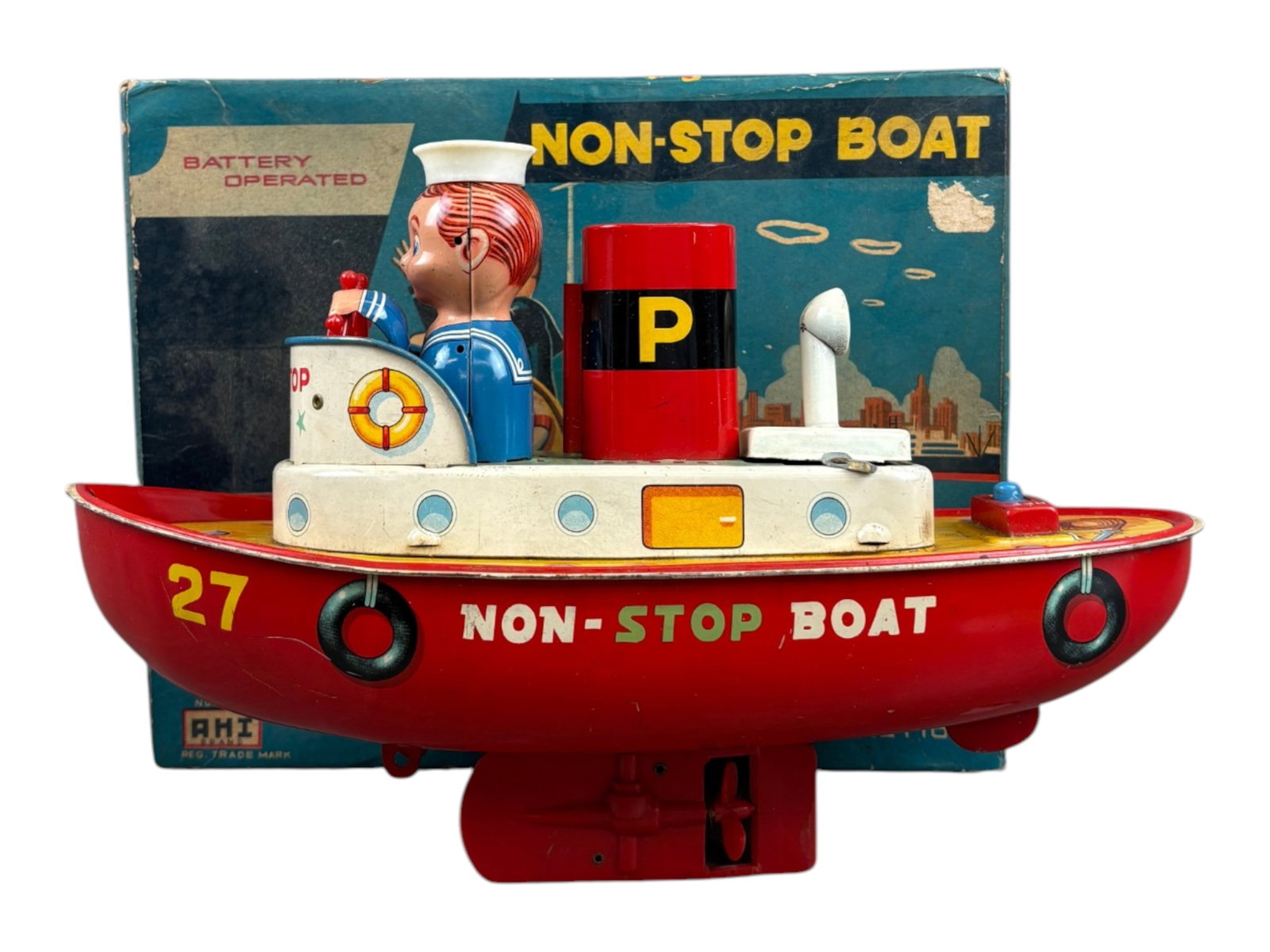 Ahi Non-Stop Battery Boat: Ahi "Non-Stop" battery-operated boat with its original box, measuring approximately 9 inches long. Toy appears fairly clean overall. The internal spiral wire and battery box have become separated.