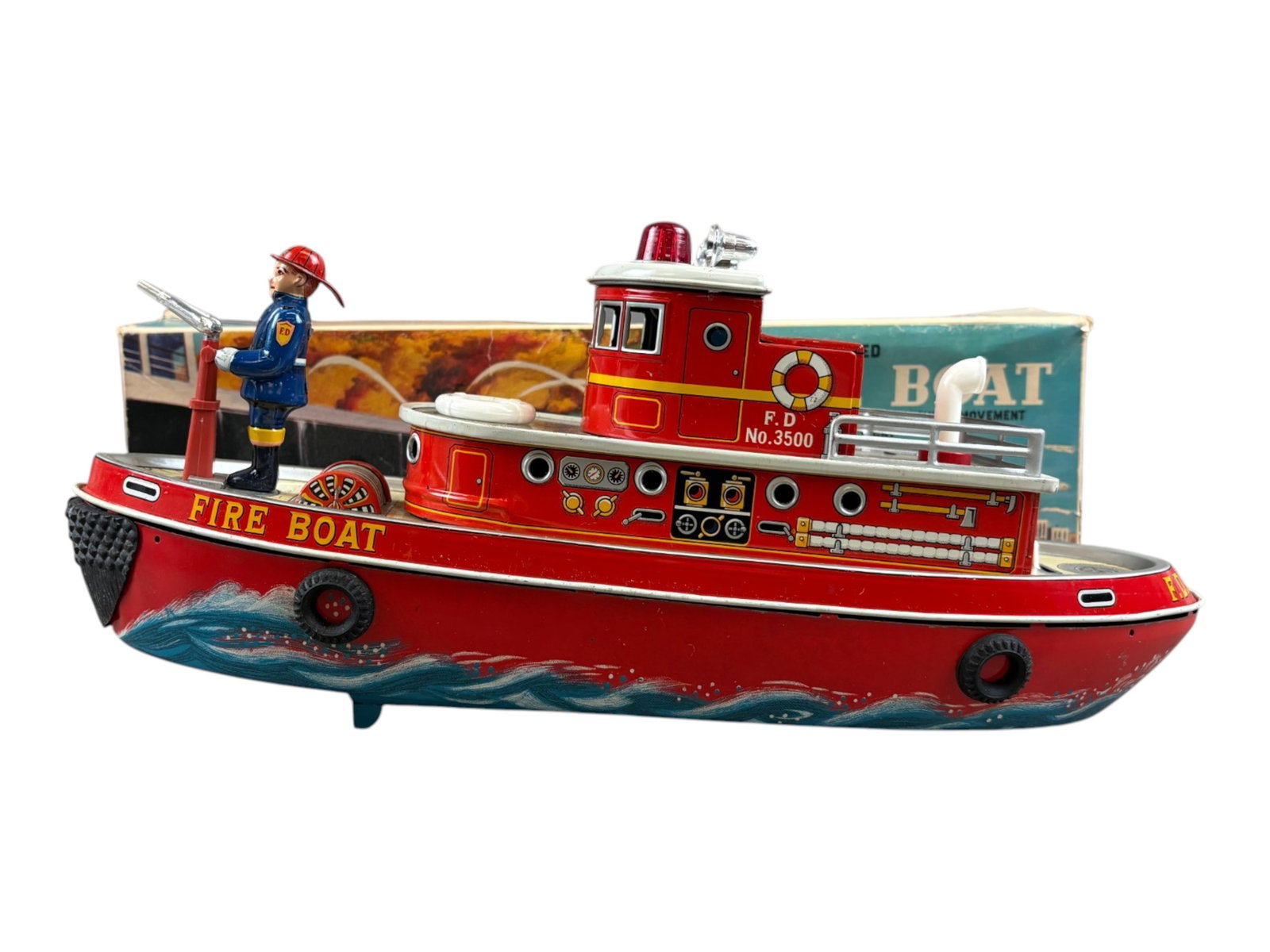 Modern Toys Fireboat: Modern Toys of Japan battery-operated tin lithographed fireboat with its original box and cardboard inserts. Features pitching movement, flashing beacon light, clanging bell sound, and an operating