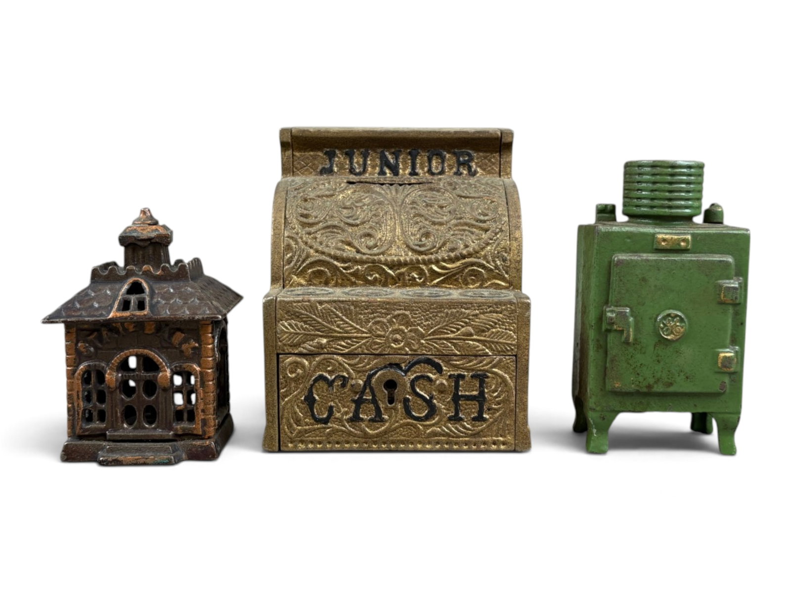 (3) Cast Iron Still Banks: Lot of three cast iron still banks. Includes a 4?-inch-tall J. & E. Stevens Junior Cash Register bank with gilt paint and black lettering in excellent condition (no key), a 3-inch State Bank , and a 4