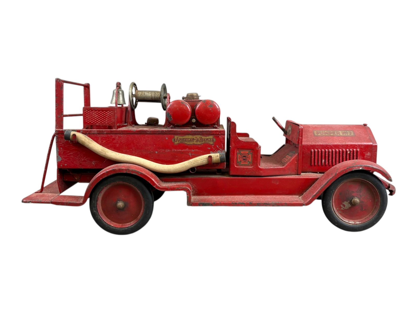 SturdiToy #7 American LaFrance Fire Truck: Vintage Sturditoy Pressed Steel #7 American LaFrance Toy Fire Truck, circa 1930's. Approx. 26" long. Missing the steering wheel, and hose around the reel. There are hoses on each side of the truck,