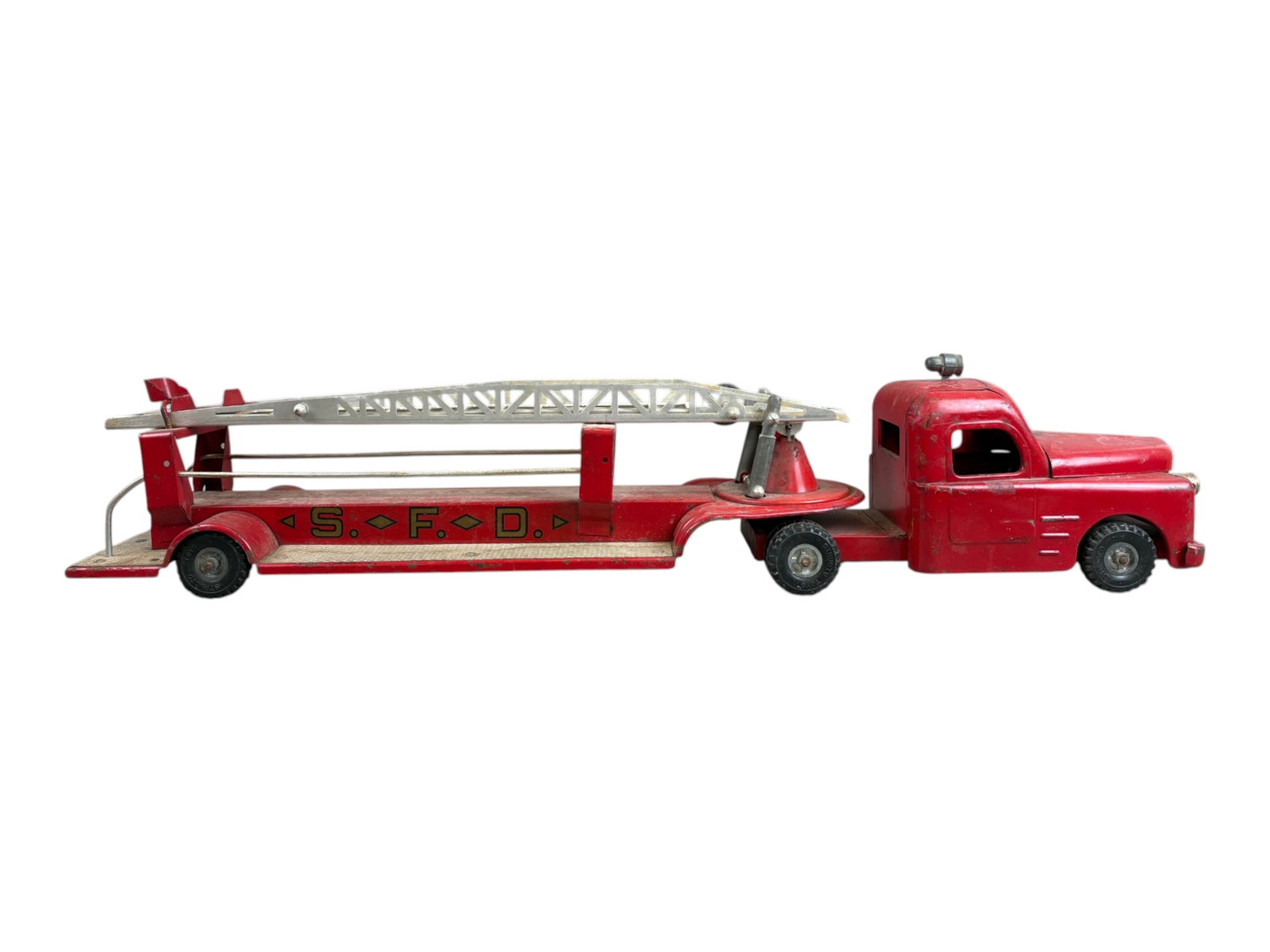 Structo Toys Aerial Ladder Fire Truck: Large Structo Toys pressed steel aerial ladder fire truck, measuring approx. 32" long. Finished in red with "S.F.D." graphics along the sides, detailed cab, rubber tires, rear platform, and long