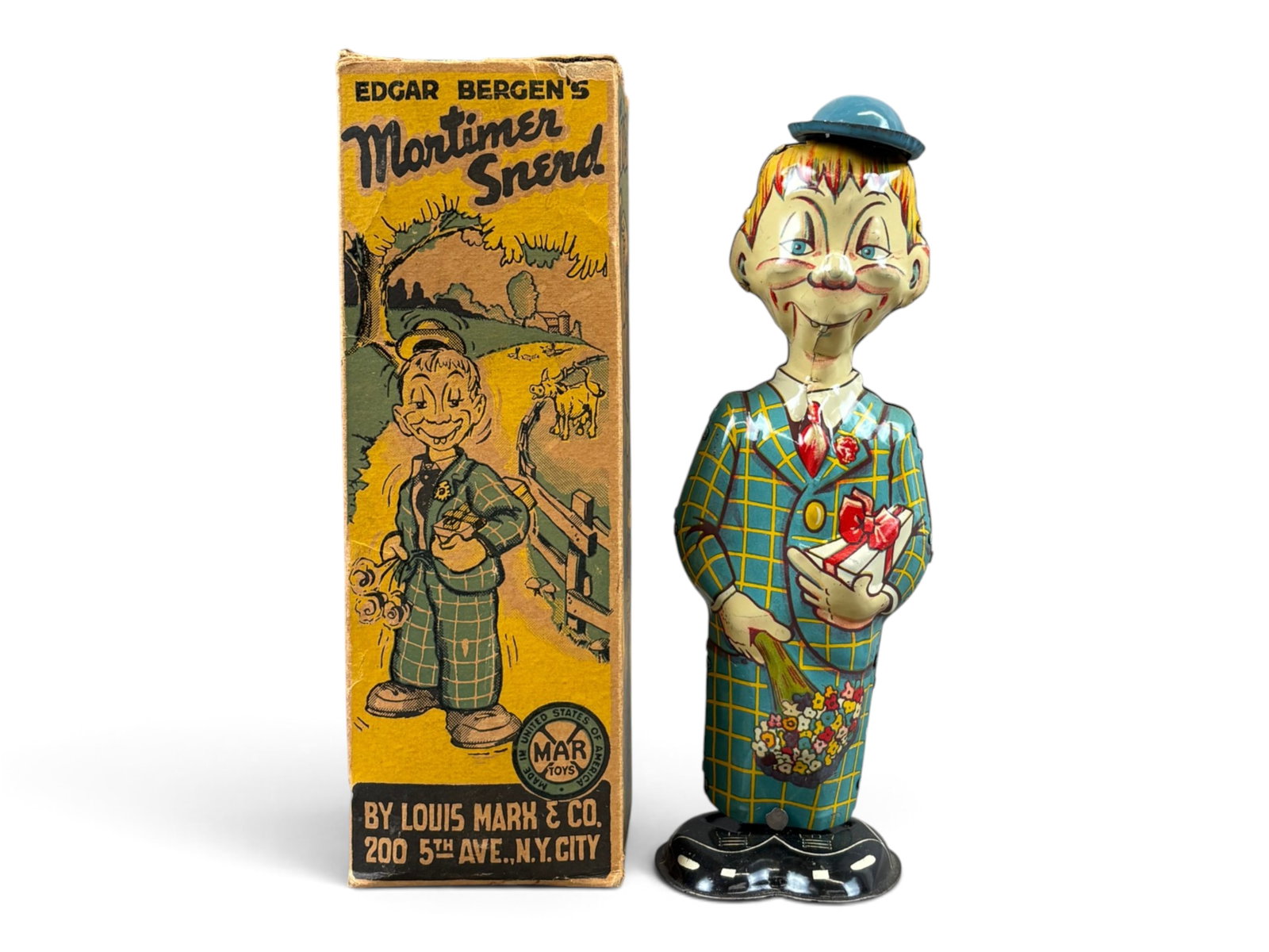 Marx Mortimer Snerd Walker: Marx tin lithographed Mortimer Snerd wind-up walker with its original box. Tested prior to cataloging and found to be in working order. Toy is in very fine to near mint condition, making it an