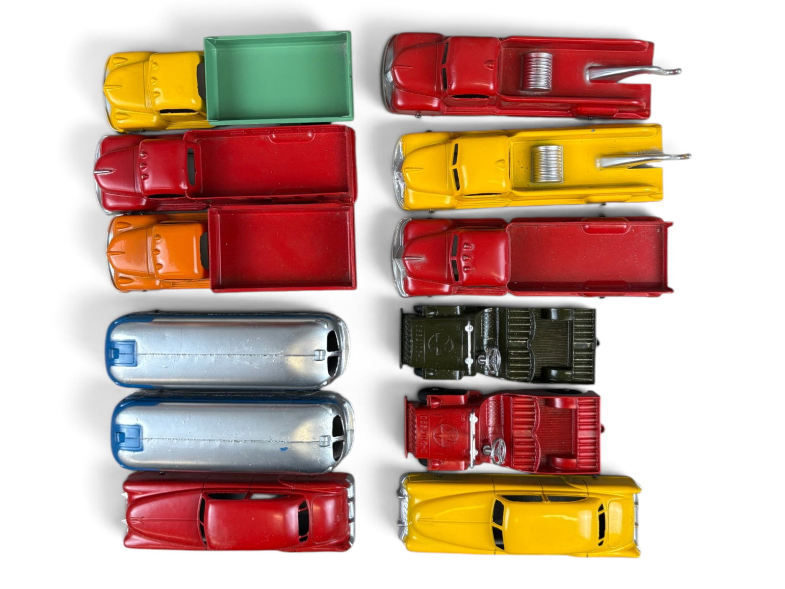 Tootsietoy Dealer Box of (12) Vehicles: Original Tootsietoy dealer's box containing 12 mint trucks and buses, including tow trucks, dump trucks, stake trucks, and other vehicles. The toys appear never to have been removed from the box. A