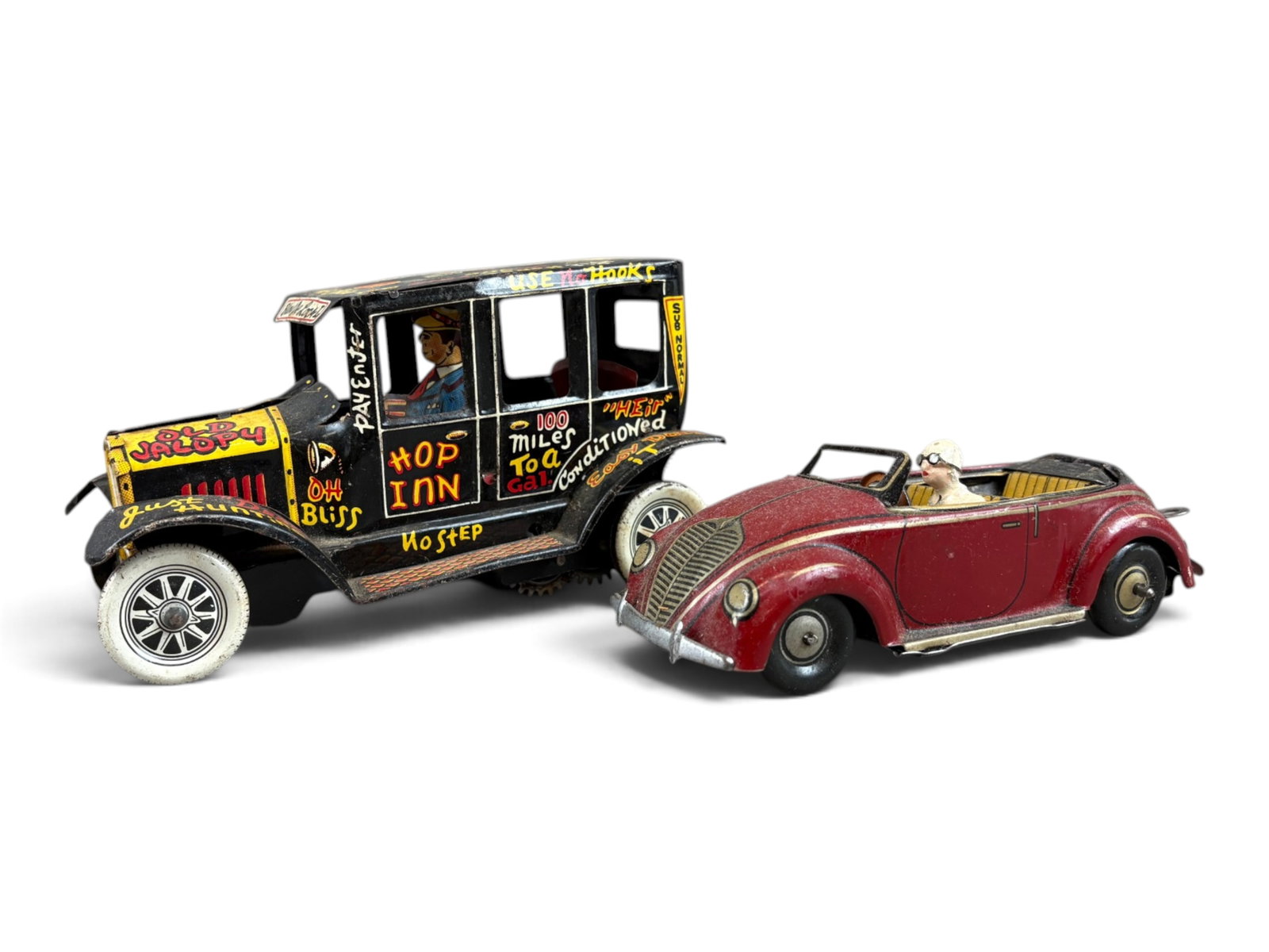 (2) Tin Wind-Up Vehicles: Lot of two vintage tin wind-up vehicles. Includes a Marx Old Jalopy measuring approximately 6? inches long, tested and found to be in working order, together with a U.S. Zone Germany K.O. wind-up open
