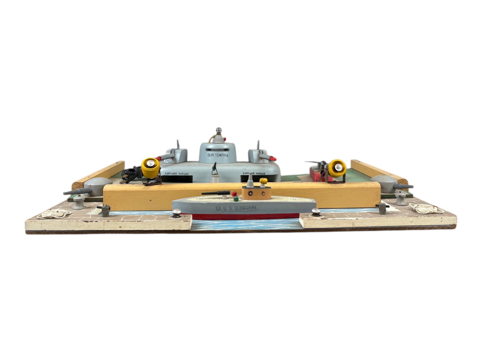 Nice Large Keystone US Coastal Defense Fort: Painted and stenciled wood, 23 1/2 X 16 1/2?. One of the more complete examples we have seen with its glider, boat, both missiles, missing the rubber tips. It has electric searchlights, signal light