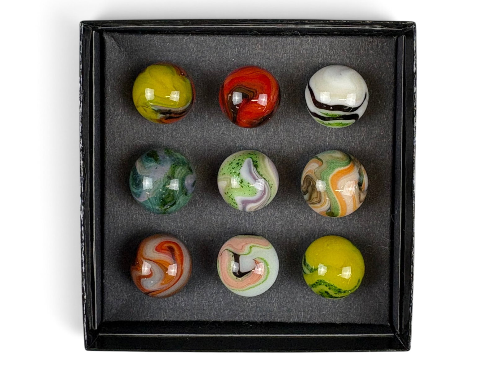 9 Peltier Mansion Marbles: Largest is 3/4" smallest 11/16" All have beautiful colors and show light handling with after market box. Shipping: Weiss Auctions offers full-service, in-house shipping for nearly all items in this