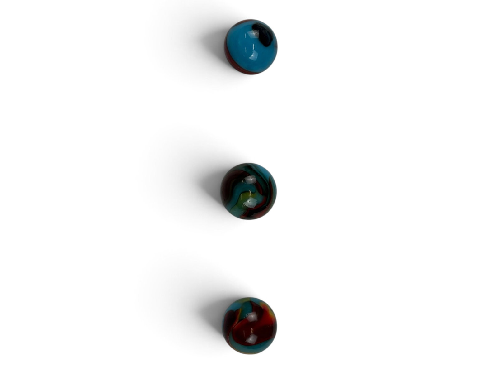 Peltier Superman & Superboy Marbles: Includes two 11/16 inch NLR Superman, with 1 having small hole near pontil(Bubble??), Super Boy, all shiny, showing light handling. Shipping: Weiss Auctions offers full-service, in-house shipping for