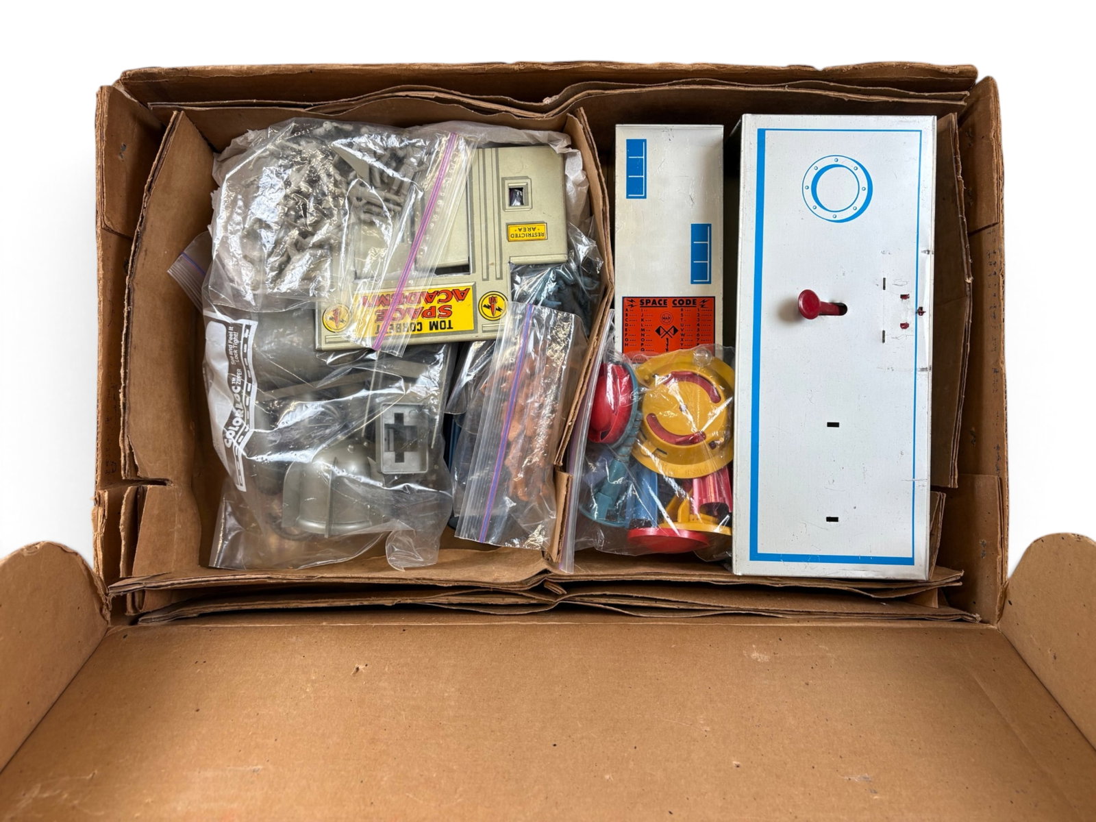 Marx Tom Corbett Space Academy Play Set 7012: Nice set that appears to have all its parts. Building parts are clean, all parts plastic bagged. No paperwork. It has a dark box that is intact, insert has moisture/delaminating damage. Not Collated.