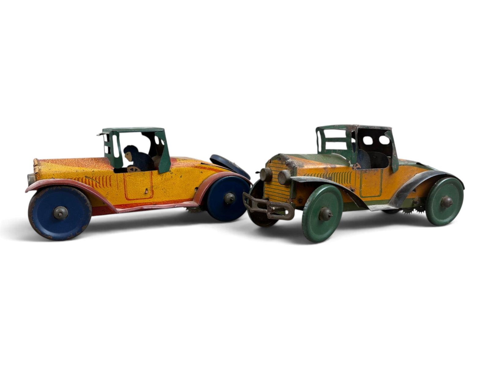 (2) Marx Tin Litho Wind Up Cars: Lot of 2. Pressed tin wind up cars by Marx. Each approx. 8-1/2" long. Windup mechanism on each is not working. The yellow/red car is missing the front bumper. Each shows playwear with scuffs, scratche