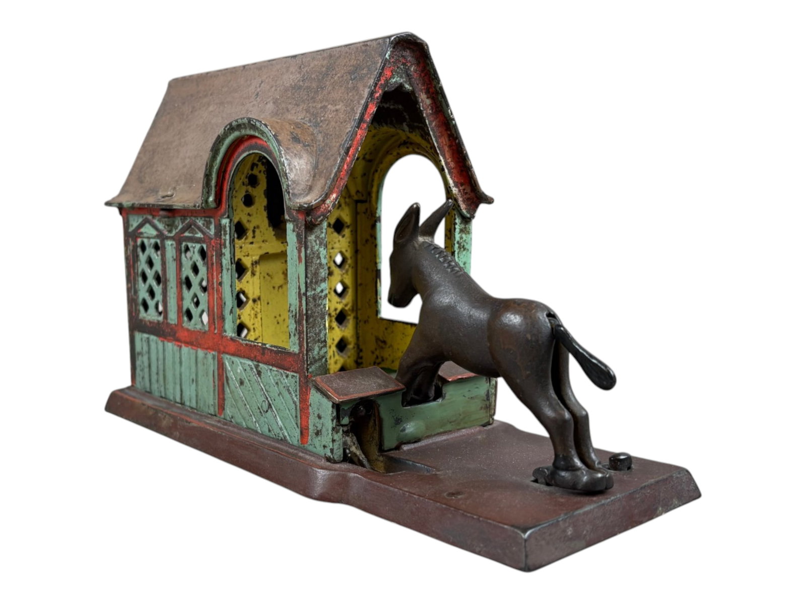 J&E Stevens Mule Entering Barn Mechanical Bank: 19th-century American cast-iron mechanical toy bank manufactured by the J. & E. Stevens Company of Cromwell, Connecticut. Light green painted barn with red trim below a light brown roof. Under base is