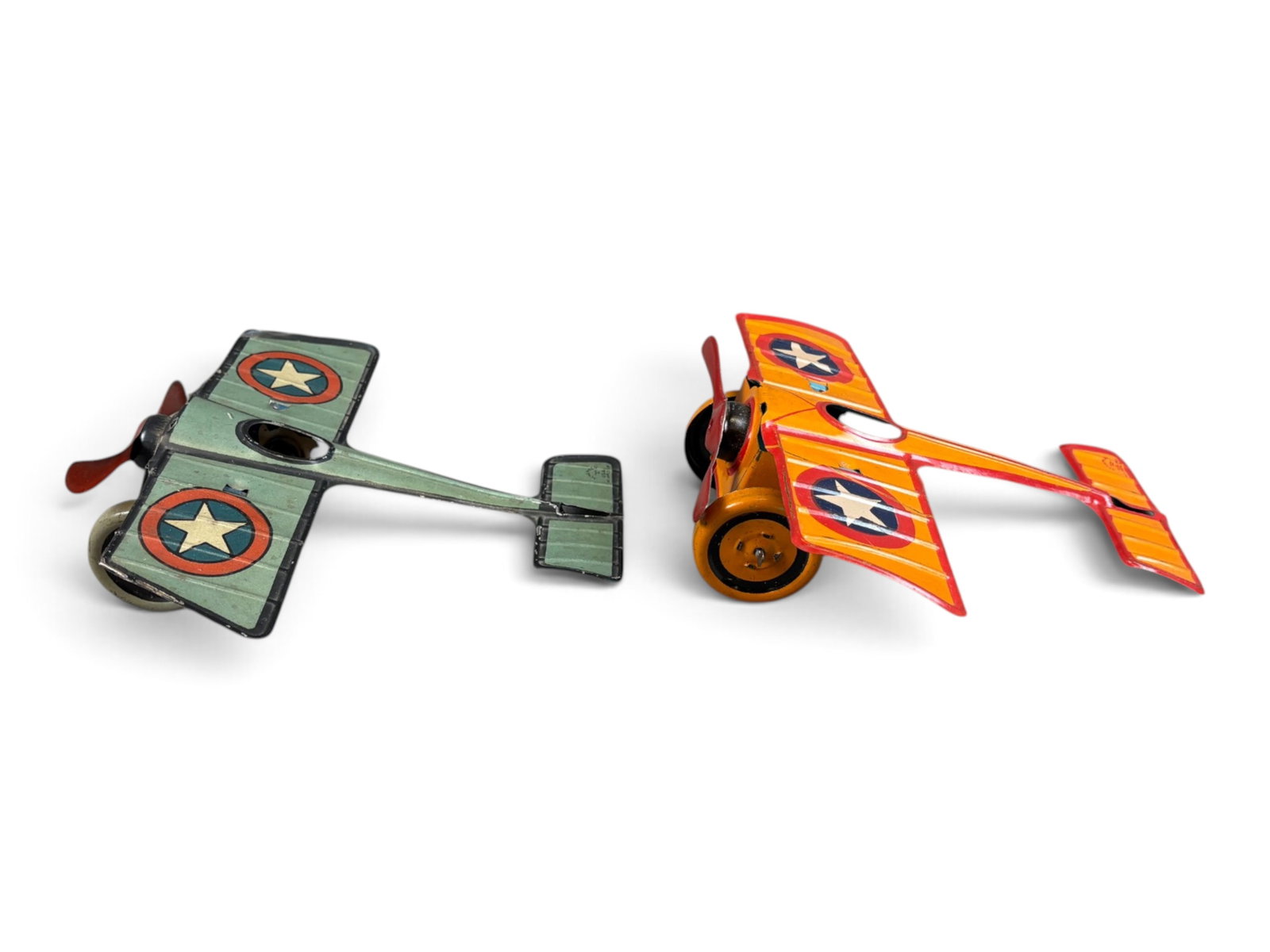 (2) Chein Tin Litho Windup Airplanes: Tin lithographed, windup. Each approx. 6" long x 6-3/4" wingspan. Windup mechanisms on each are currently not working, as they are overwound. Each shows light wear with light scuffs and scratches.