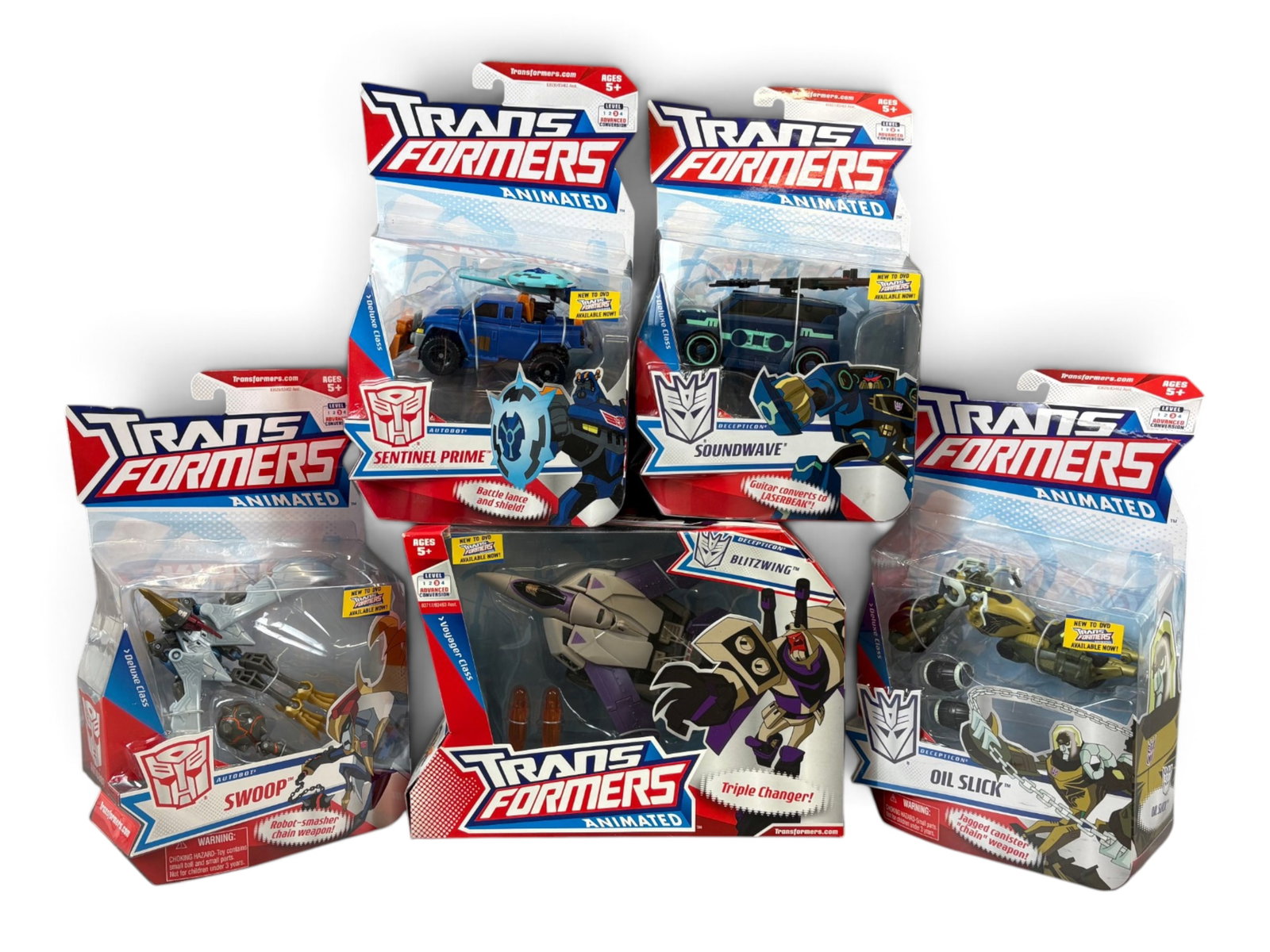 (5) Sealed Transformers Animated Action Figures: Hasbro, 2008. Group of 5 Sealed, New in Package Transformers Animated action figures. Includes Blitzwing, Oil Slick, Soundwave, Swoop, and Sentinel Prime. Packing to each may show edge and corner