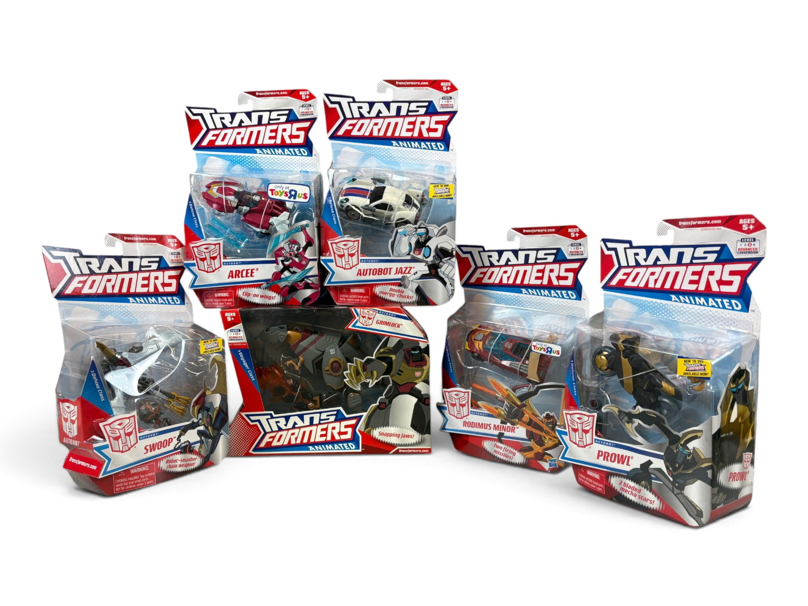 (6) Sealed Transformers Animated Action Figures: Hasbro, 2008. Group of 6 Sealed, New in Package Transformers Animated action figures. Includes Grimlock, Swoop, Arcee, Autobot Jazz, Prowl, and Rodimus Minor. Packing to each may show edge and corner