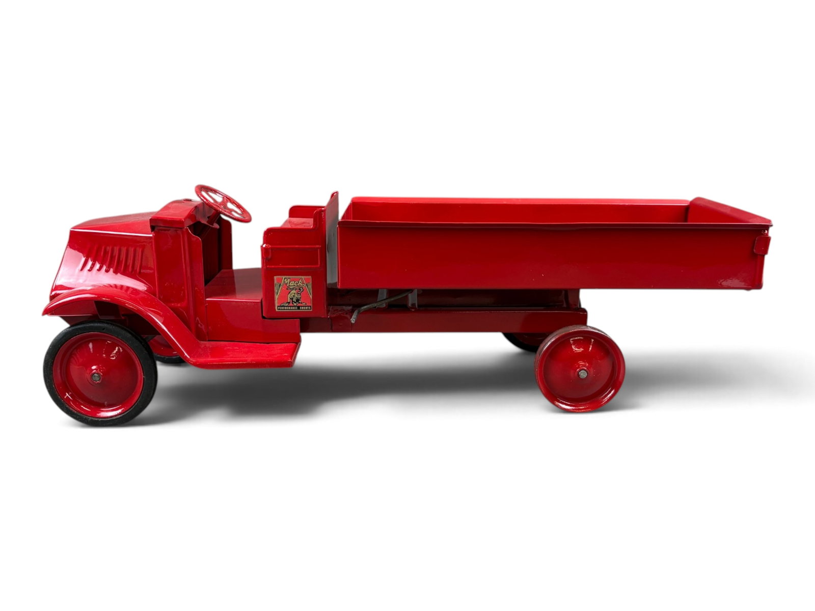 Restored Steelcraft Open Cab Mack Dump Truck: Approx. 25" long. Missing 1 rubber tire, and the other 3 tires show some wear. Decals are not original. Shipping: Weiss Auctions offers full-service, in-house shipping for nearly all items in this